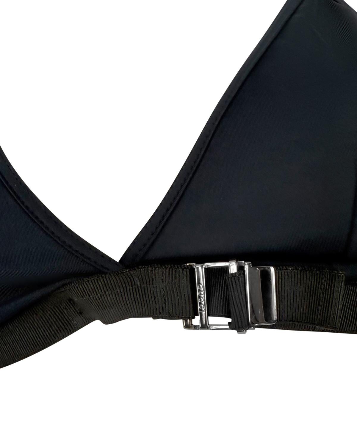 From Gucci’s Spring/Summer 2000 collection under Tom Ford, this minimalist bikini swim top features a deep V neckline with slender straps and a sleek black elastic underband. The piece is finished with a branded silver-toned adjustable buckle at the