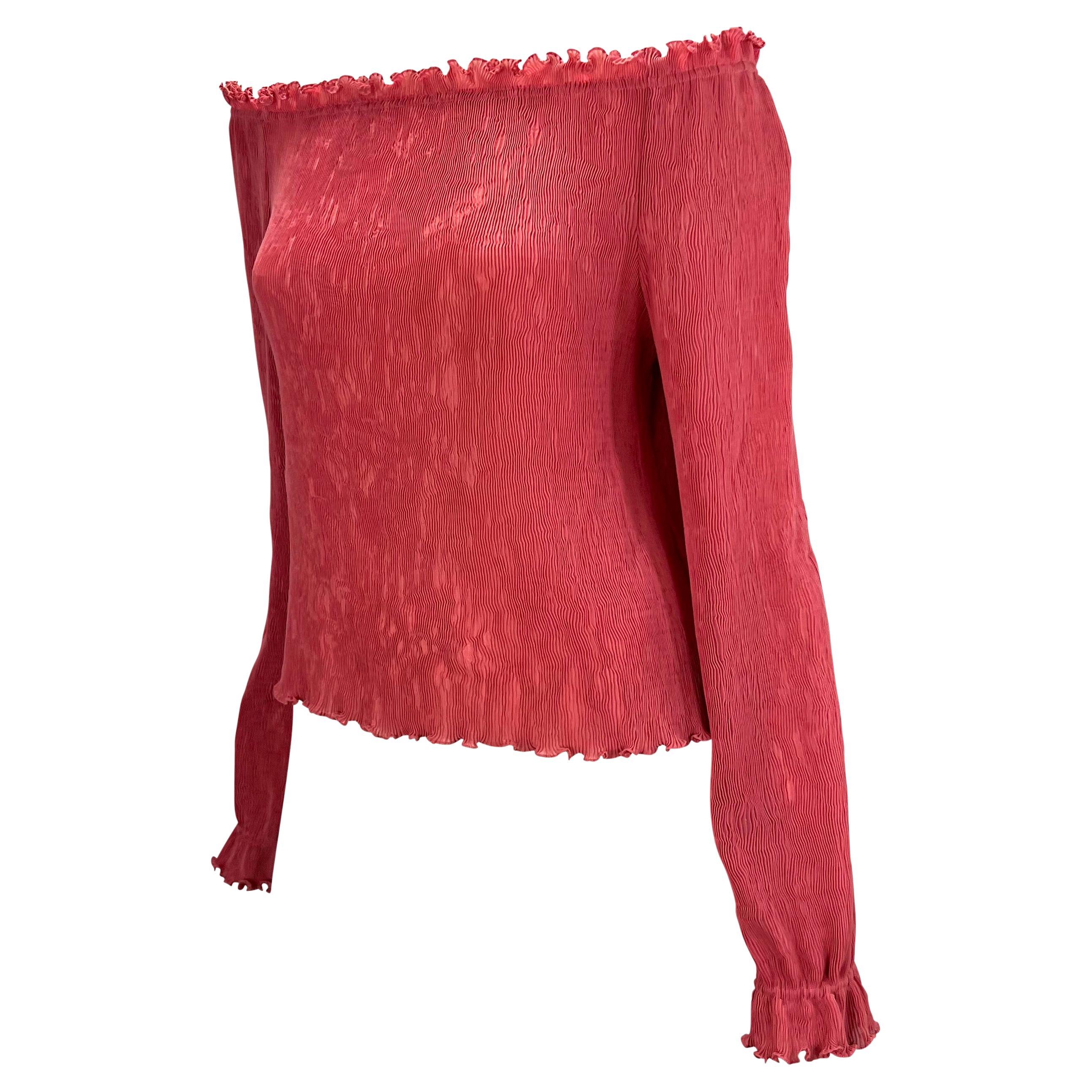 Presenting a hot pink pleated Gucci top, designed by Tom Ford. From the Spring/Summer 2000 collection, this top features a boat neck off-the-shoulder neckline with ruffle finishes at the neckline, cuffs, and hem. This must-have top is the perfect