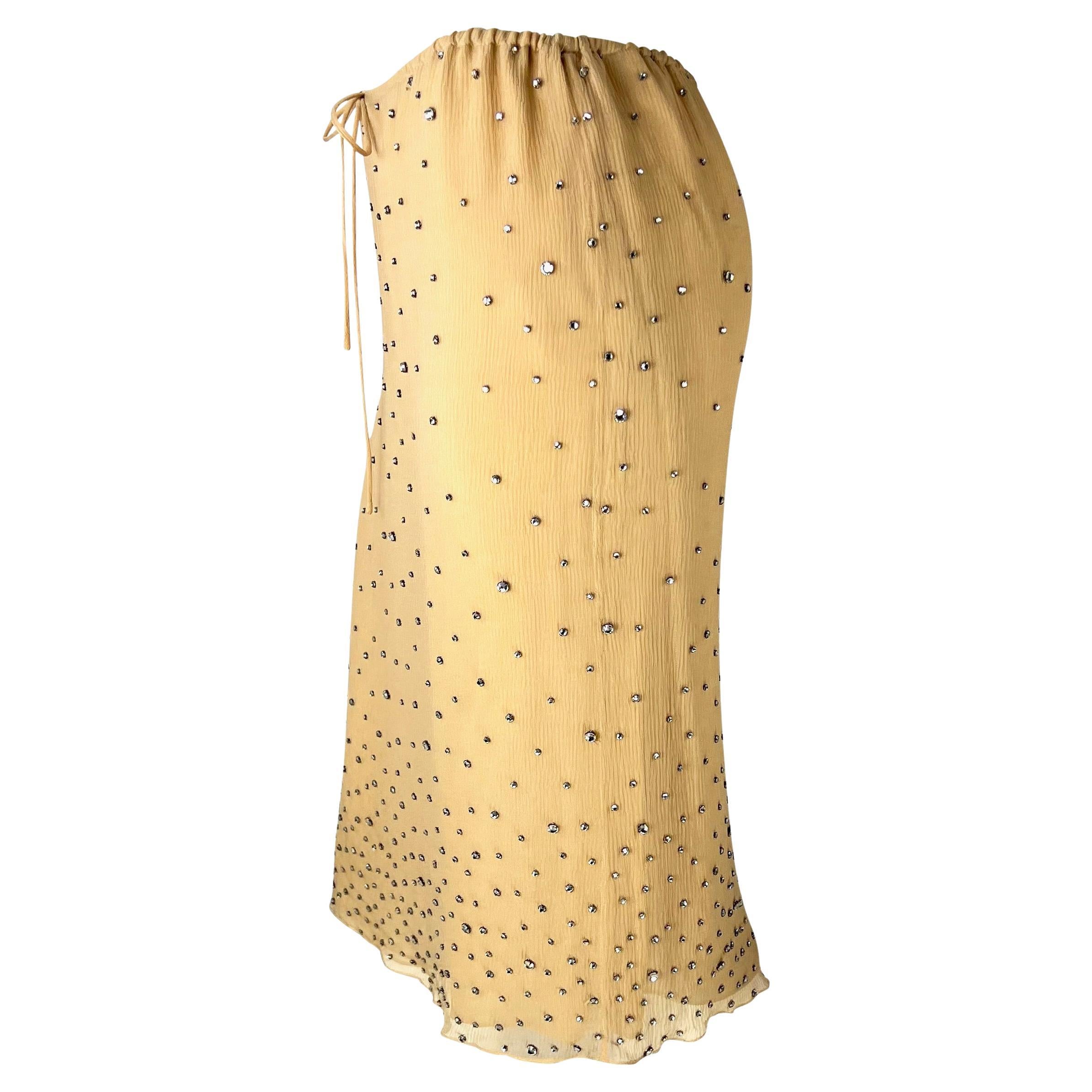 TheRealList presents: an incredible and rare beige silk Gucci skirt, designed by Tom Ford. From the Spring/Summer 2000 collection, this stunning beige silk shirt is covered in clear rhinestones of varying sizes. Incredibly rare and virtually never