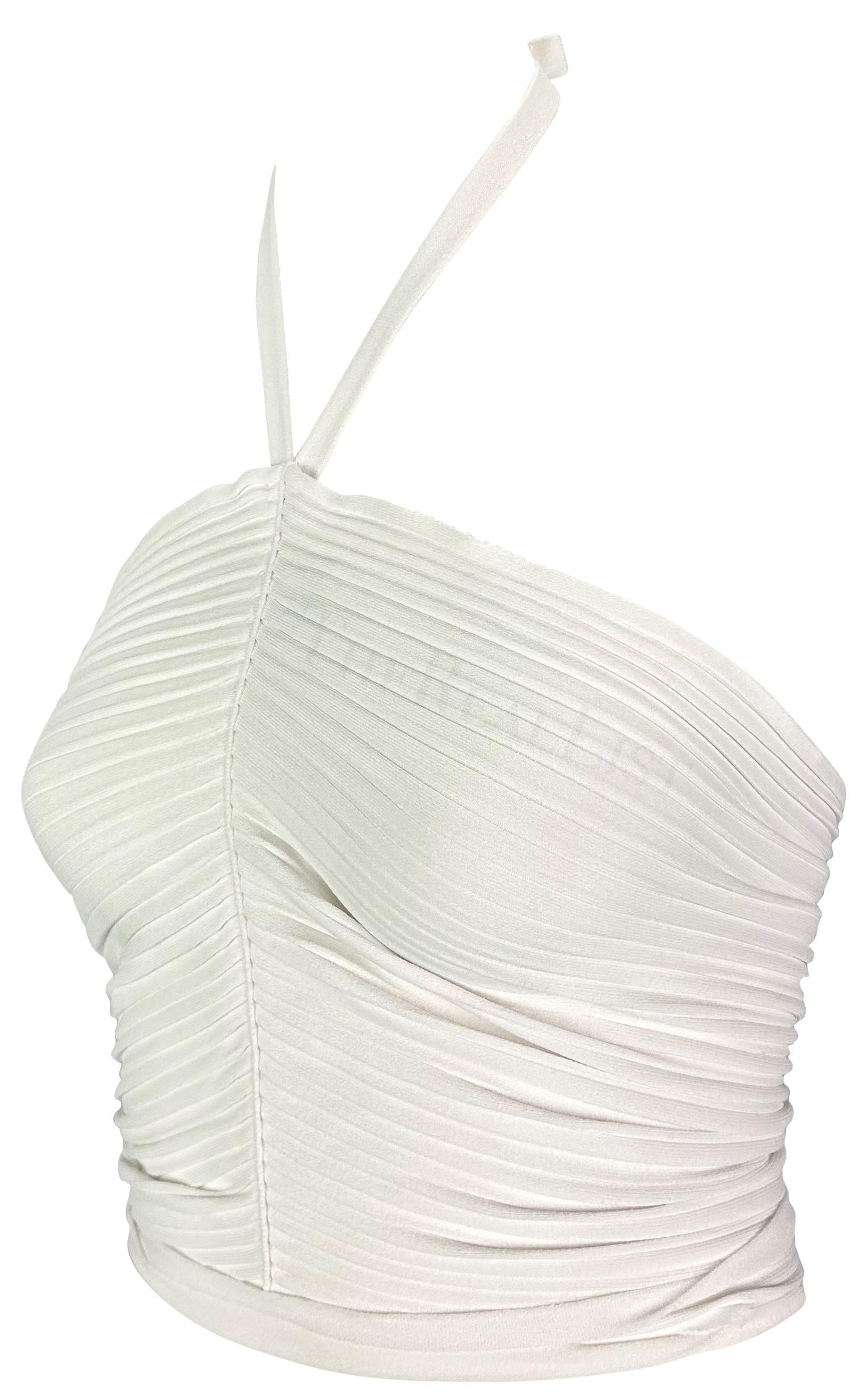 Presenting a form-fitting white Gucci cropped halterneck top, designed by Tom Ford. From the Spring/Summer 2000 collection, this ribbed top clings to the body. Featuring a seam down the front, this halterneck top naturally ruches and is made