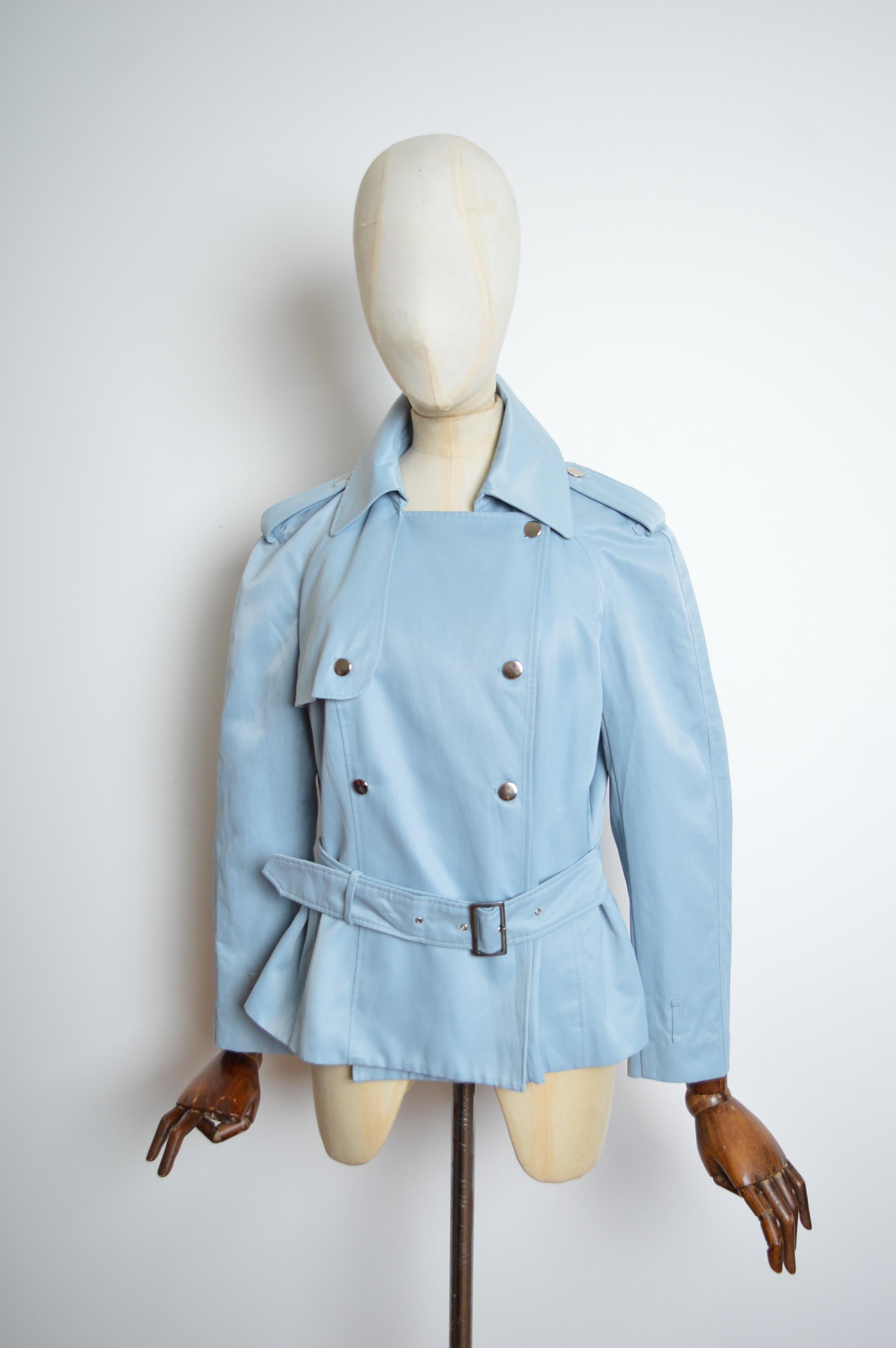 Superb Pale Blue short Belted Trench style Jacket from John Galliano’s Spring 2000 Collection.
Features - double breasted front / chrome buttons / belted waistline / bracelet length sleeves / silk lined interior.
Size; the Label states EU 46 however