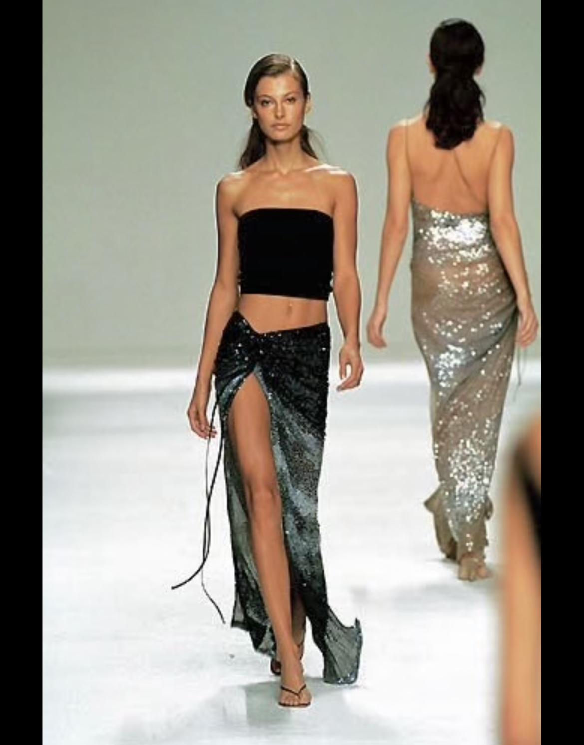 From Randolph Duke’s Spring/Summer 2000 collection, this yellow silk wrap skirt features an orange ombré fade and is fully embellished with tonal sequins. Gathered at the hip with a drawstring tie, this fluid silhouette shimmers with movement. A