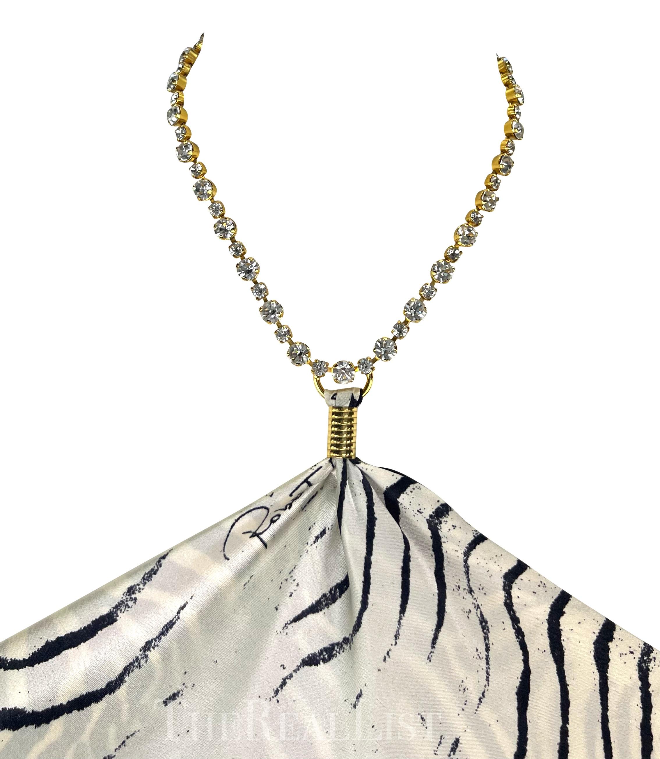 Presenting a fabulous zebra print Roberto Cavalli silk scarf top. From the Spring/Summer 2000 collection, this piece can be tied multiple ways and is made complete with a gold rhinestone chain halter neck. Perfect for a day at the beach or a night