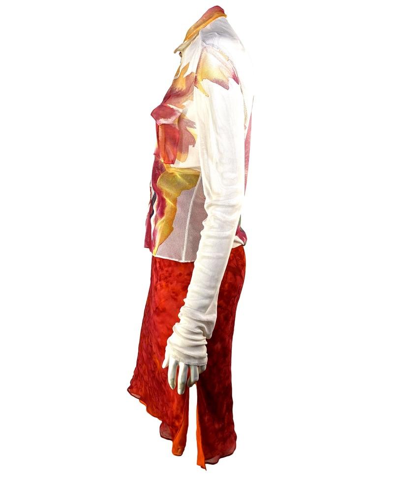 Presenting a watercolor tie-dye three-piece blouse belt and skirt set. The zip-up blouse is constructed of sheer mesh and features a 'D' shaped initial zipper pull, two pockets at the bust, and a sheer chiffon collar. The skirt is constructed of