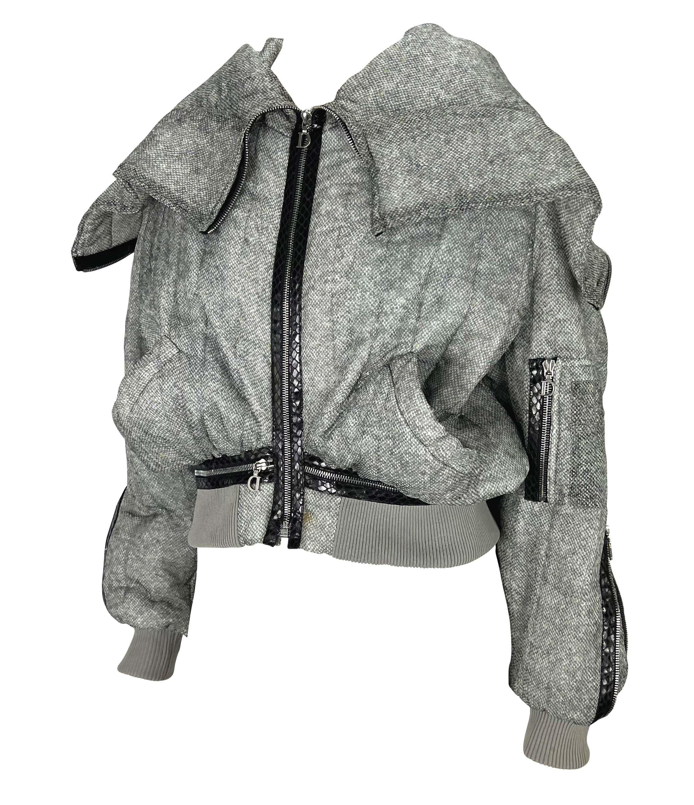TheRealList presents: a grey snakeskin print Christian Dior Boutique puffer jacket, designed by John Galliano. From the Spring/Summer 2001 collection, This stunning coat is covered in snakeskin adorned zippers perfectly decorated with shiny 'D'