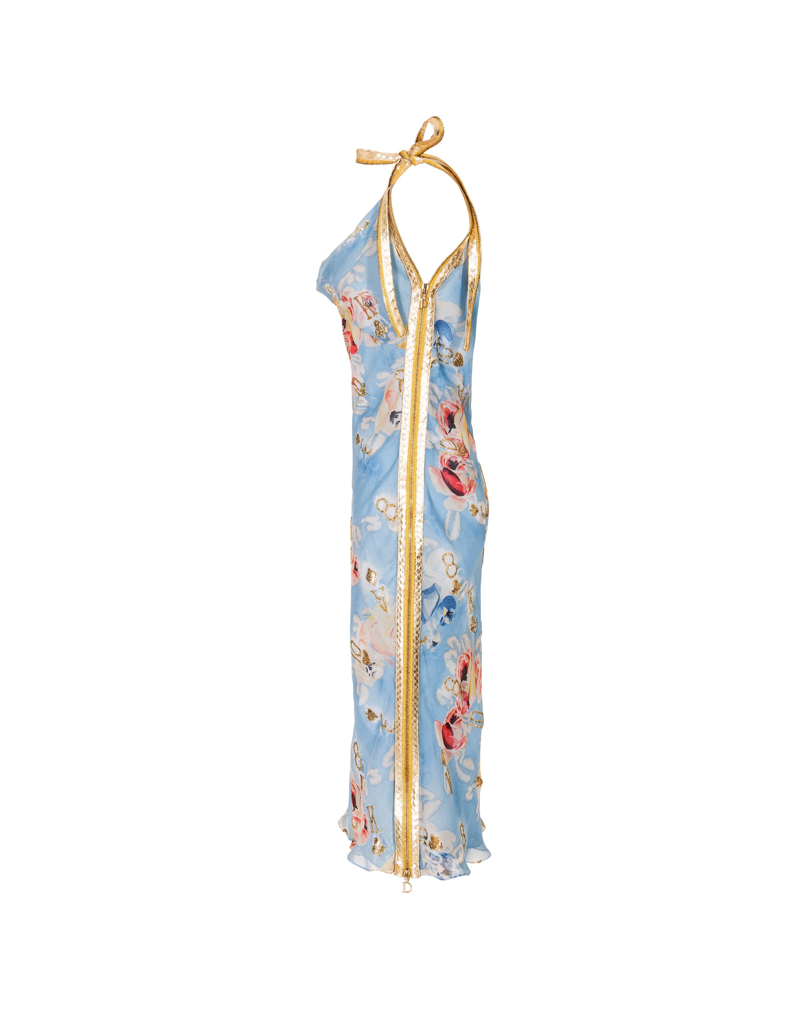 S/S 2001 Christian Dior by John Galliano floral print bias cut silk chiffon dress with gold tone playing card glitter details throughout. Below-knee sleeveless cowl neck midi dress with gold faux snakeskin leather bow at right shoulder, and gold