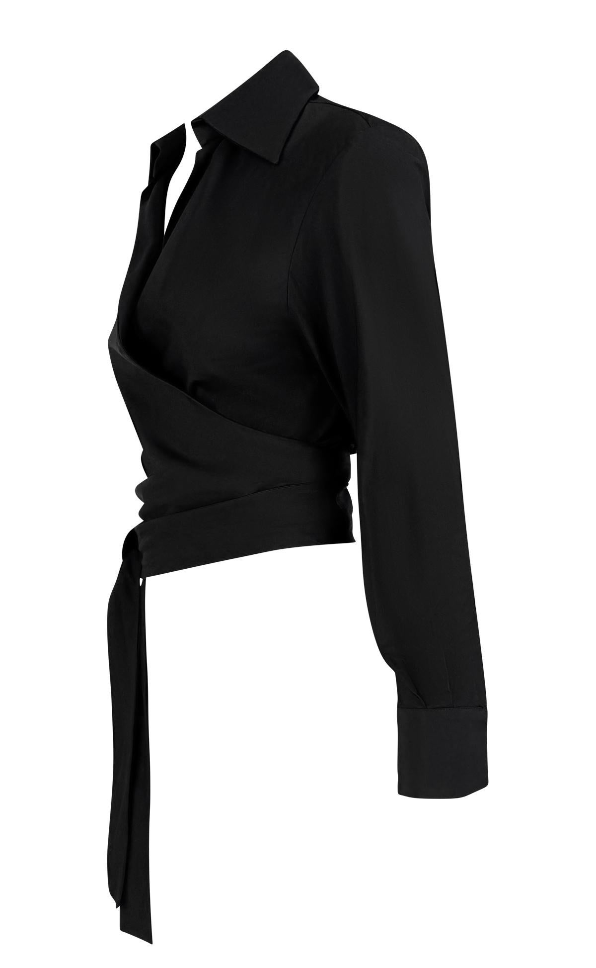 From Gucci’s Spring/Summer 2001 collection under Tom Ford, this black cotton crop top features a deep plunging neckline, structured collar, and an asymmetrical wrap silhouette that ties at the waist.

Approximate measurements:
Size - IT40
Shoulder