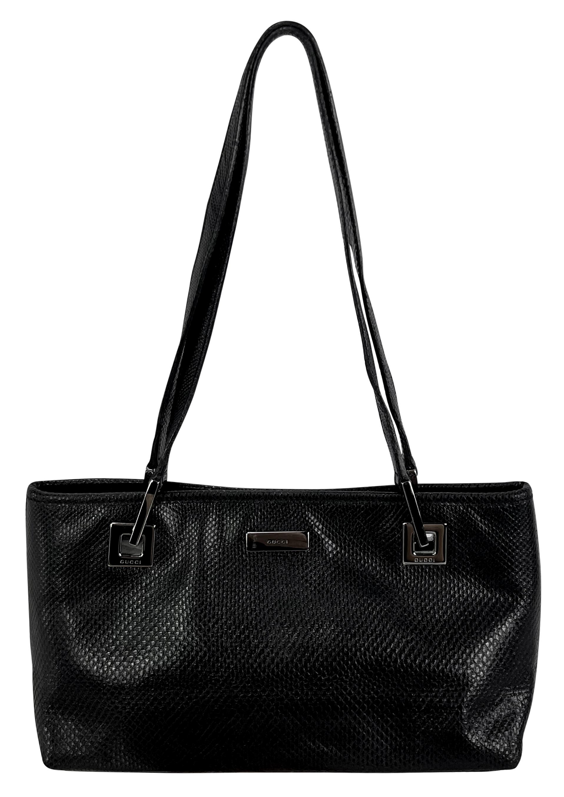 Tom Ford designed this petite black snakeskin Gucci tote for his Spring/Summer 2001 collection at Gucci. This gorgeous shoulder bag is constructed entirely of genuine karung and features chrome hardware. 

Approximate Measurements:
Length: