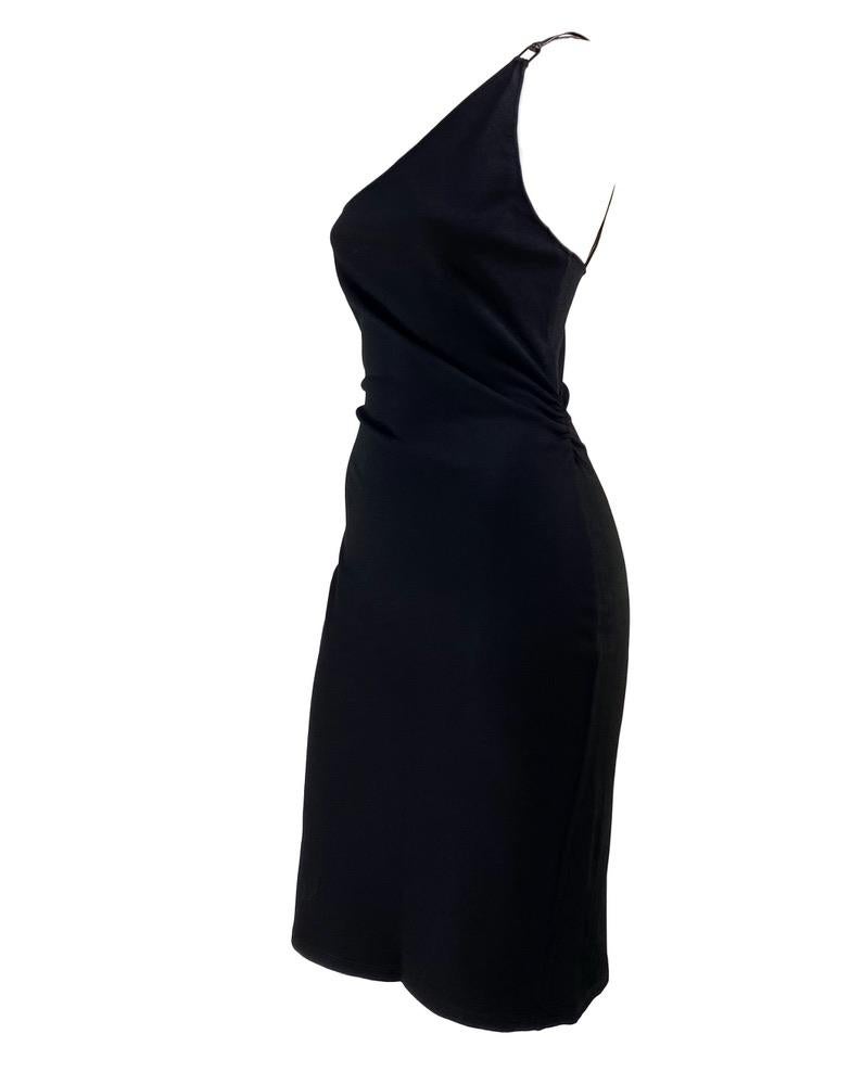 Presenting a form fitting black knit one shoulder leather strap Gucci dress, designed by Tom Ford. This stunning dress is from Ford's Spring/Summer 2001 collection and is the perfect little black dress. The dress features a ruched side at the waist