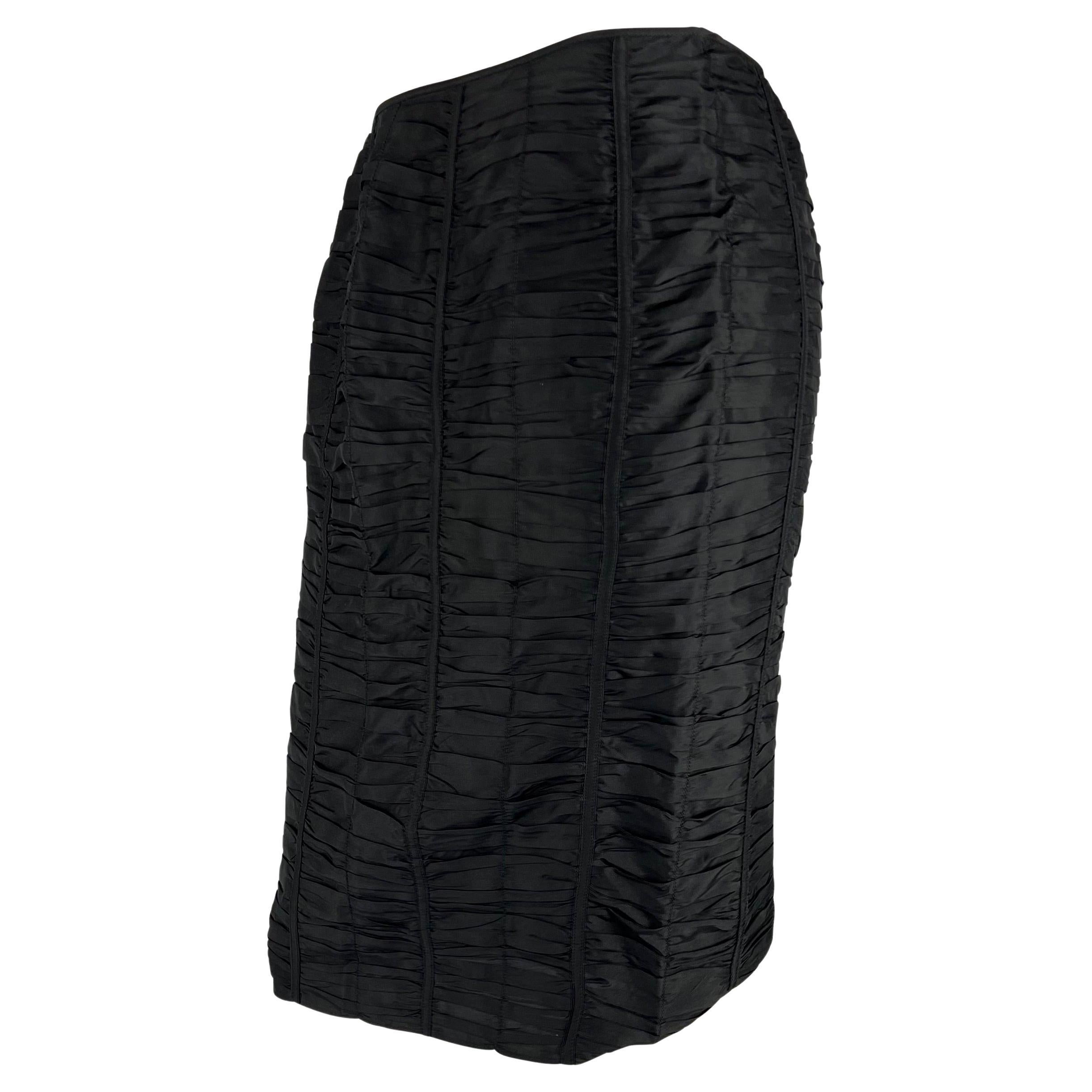 Presenting a black ruched Gucci skirt, designed by Tom Ford. From the Spring/Summer 2001 collection, this silk skirt features panels of sewn-down ruches and a silt at the back. This 'new old stock' piece has never been worn and still has the