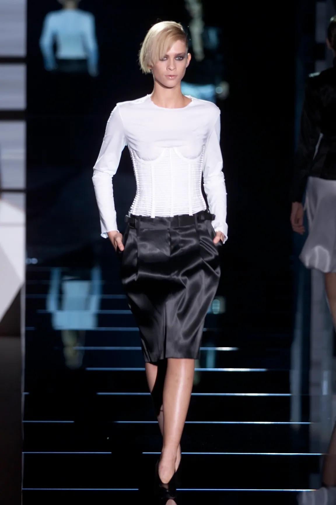Presenting a chic black silk satin skirt by Gucci, designed by Tom Ford from the Spring/Summer 2001 collection. This pencil skirt made its debut on the season's runway as part of look 16, worn by model An Oost. Constructed entirely of silk satin,