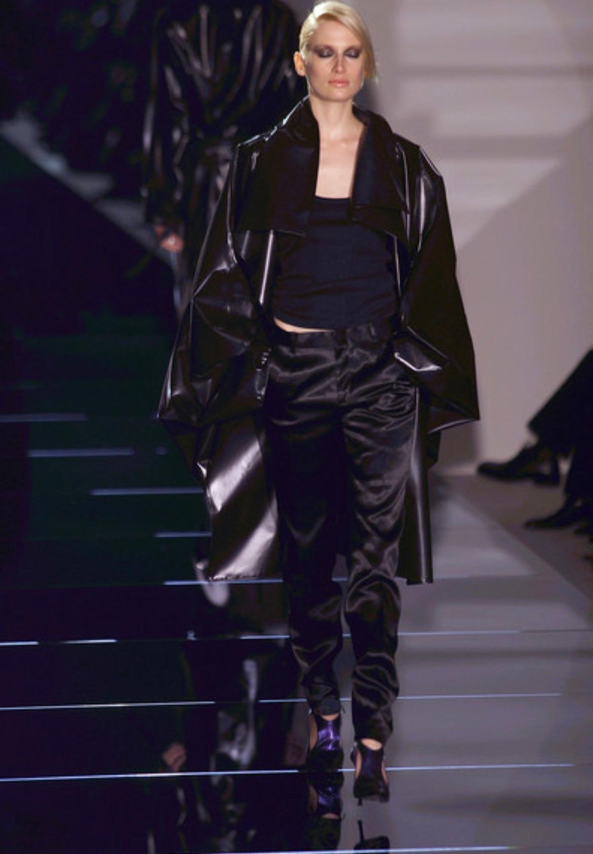 Presenting a pair of black satin Gucci pants, designed by Tom Ford. These incredible pants debuted on the Spring/Summer 2001 runway as part of look 12 modeled by Nina Heimlich and were also used in looks 19, 42, 44, and 47. Constructed entirely of a