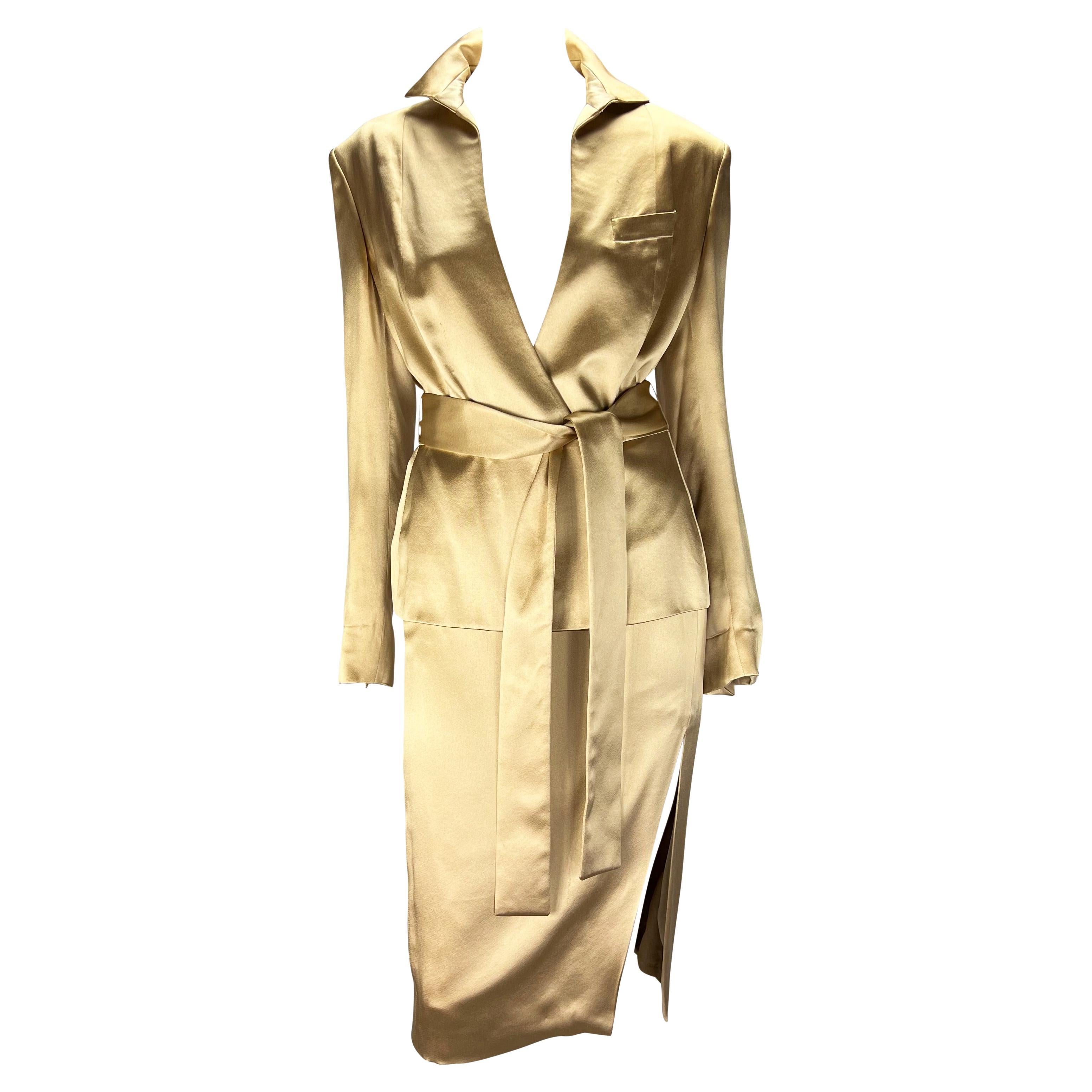 TheRealList presents: an absolutely stunning champagne silk satin Gucci skirt set, designed by Tom Ford. A sample set from the Spring/Summer 2001 collection, this two-piece set is made up of a pencil skirt and matching wrap jacket. Both pieces are