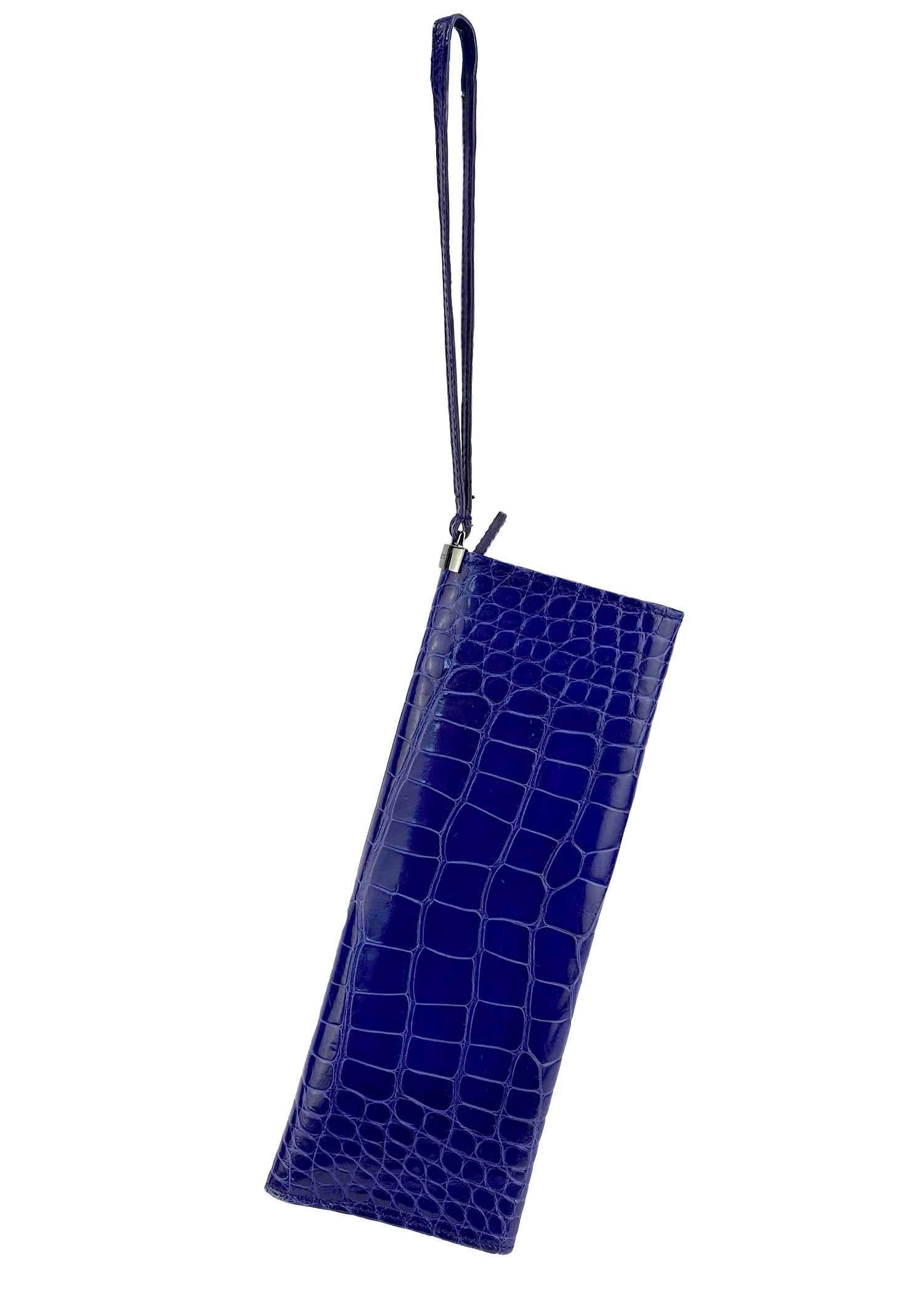 Presenting a striking alligator wristlet clutch designed by Tom Ford for Gucci's Spring/Summer 2001 collection. The rich purple color was heavily featured in the season's runway presentation and the sleek design mirrors the collection's minimalist