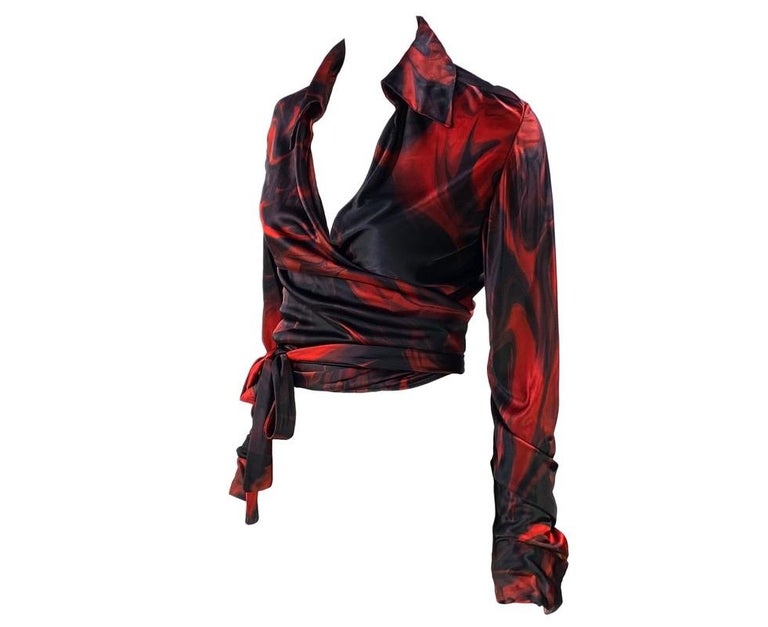 TheRealList presents: a stunning red lava print wrap around Gucci top, designed by Tom Ford. The design debuted on the men's Spring/Summer 2001 runway and was used heavily in womenswear. This print was quite popular and a shirt in this pattern was