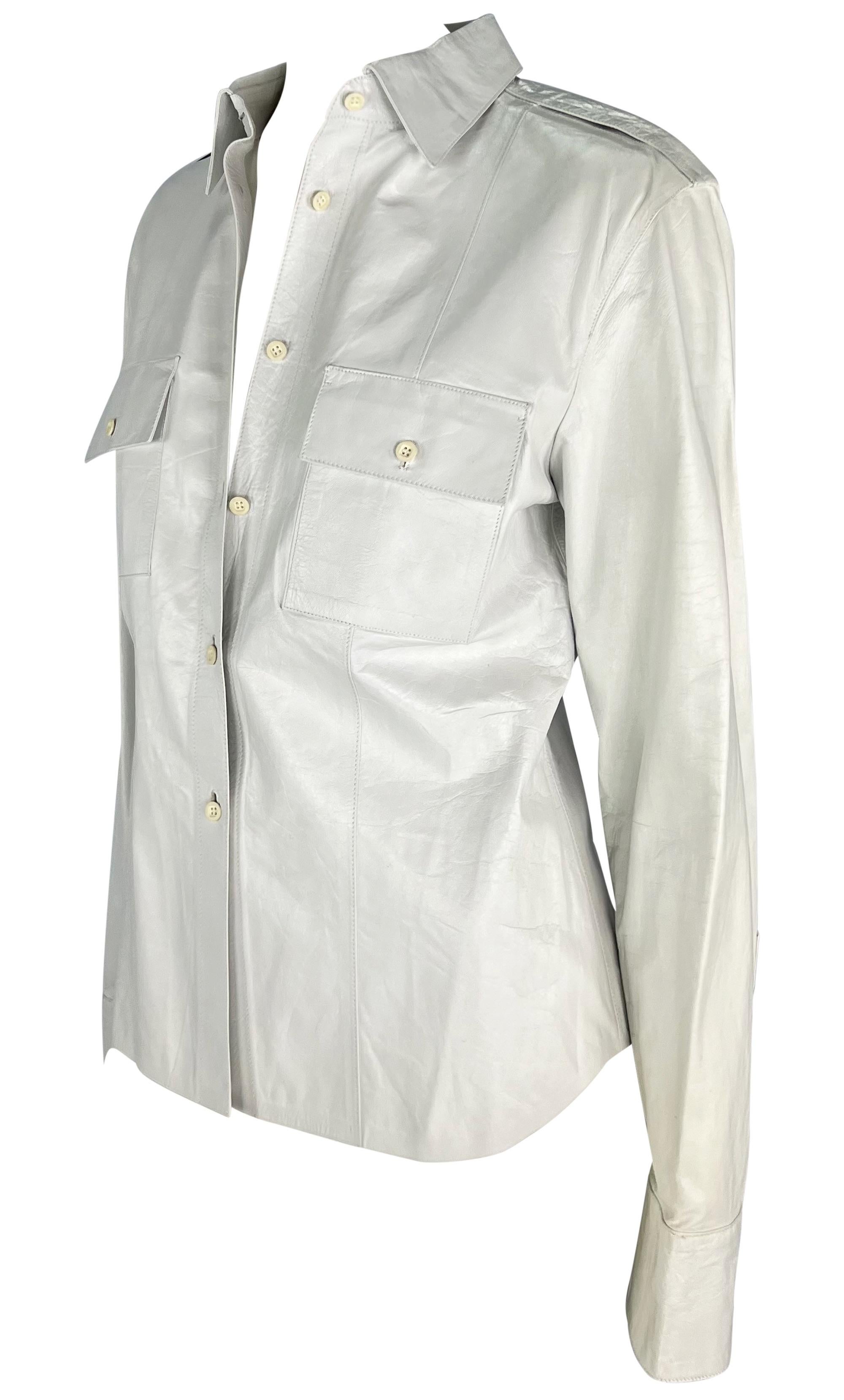 Tom Ford designed this white leather Gucci shirt jacket for the Spring/Summer 2001 collection. This classic collared shirt is constructed entirely of shiny white leather and is complete with fold-over pockets at the bust and chic epaulets.
