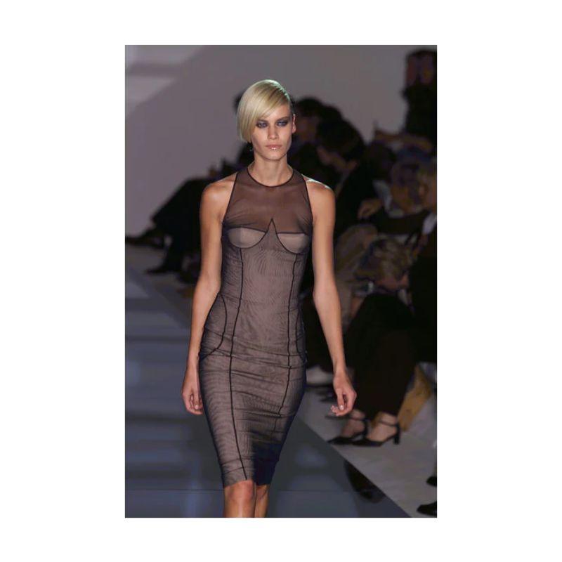S/S 2001 Gucci by Tom Ford body contouring mesh sleeveless corset above-knee dress. Designed of an inner tan boned bodice corset dress with an overlay of black sheer mesh. Padded cups, with a pocket for additional padding with unique circular