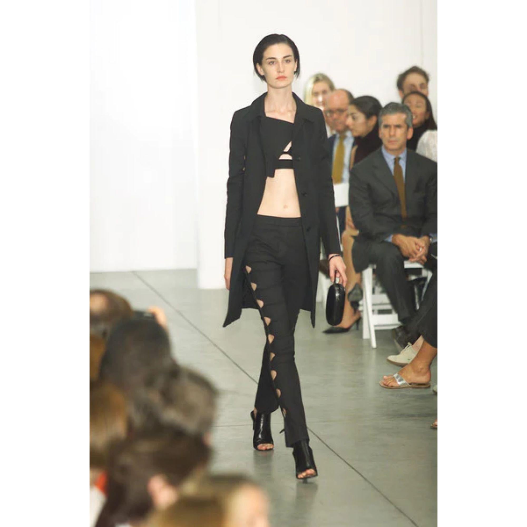 S/S 2001 Helmut Lang black side cutout pants. Mid-rise trouser with futuristic thin cutouts at sides, and thin black straps at hip. As seen on the runway. Matching shirt available (listed separately). In excellent vintage condition with no flaws to