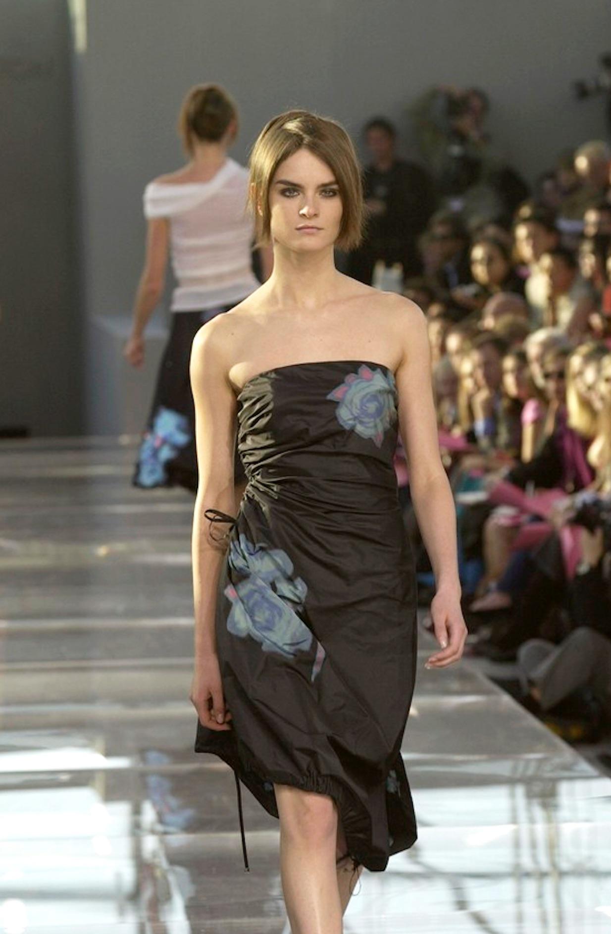From Louis Vuitton’s Spring/Summer 2001 collection by Marc Jacobs, this strapless black dress is crafted from crisp silk taffeta and printed with painterly blue and green floral motifs. Debuting on the season's runway, the design features ruched