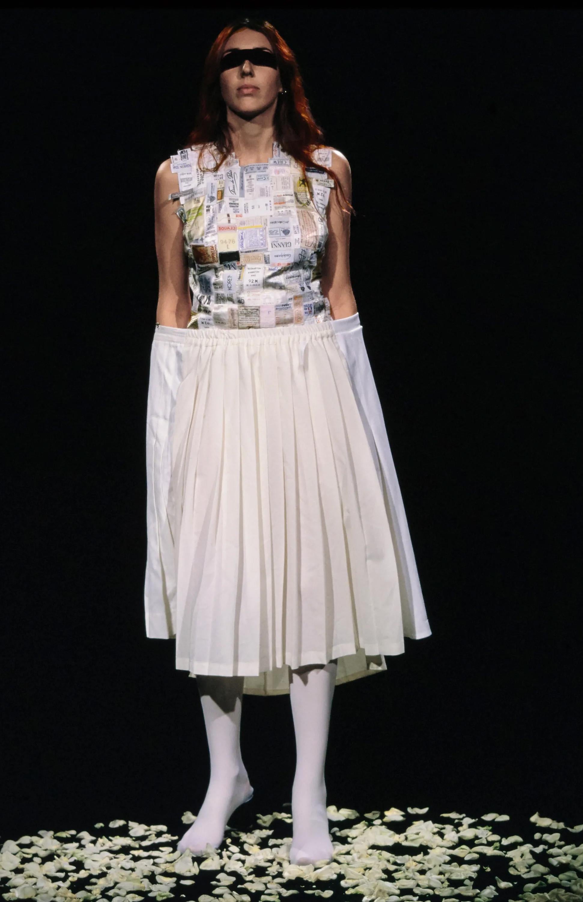S/S 2001 Maison Martin Margiela one-of-one artisanal ecru pleated skirt with asymmetrical deconstructed structure. Concealed back zip closure, with built-in interior button closure to create asymmetrical side 'pocket' appearance. Oversized hook and