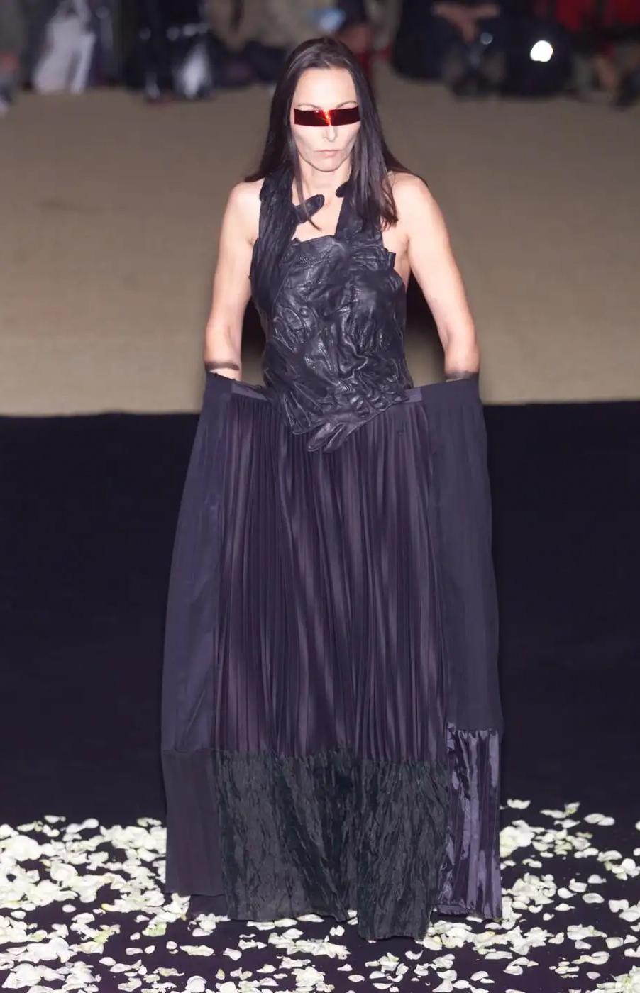 S/S 2001 Maison Martin Margiela black pleated maxi skirt. A one-of-one artisanal creation utilizing used fabrics, with what appears to be black silk crepe, wool, semi-sheer silk chiffon crinkle, and silk-satin contrasting pleated paneling (silk