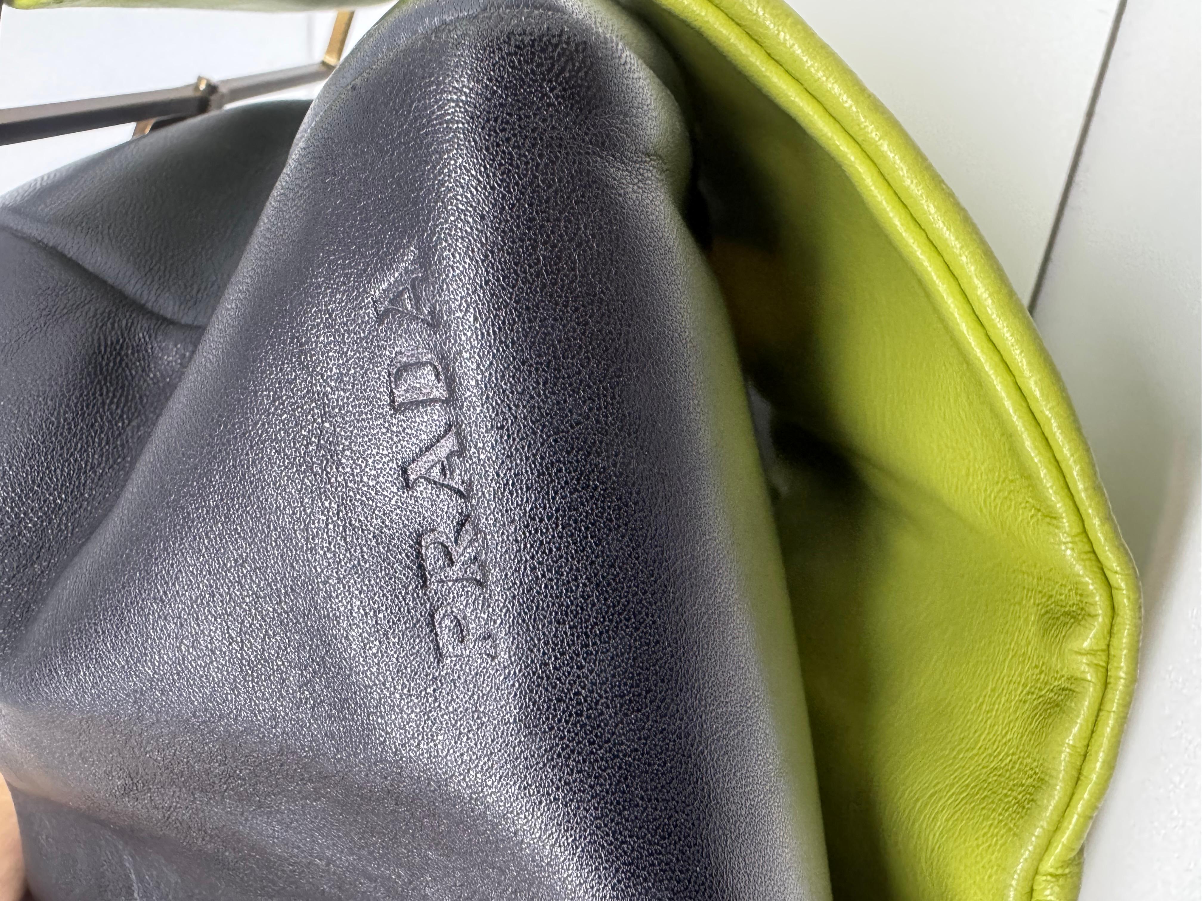 Prada rectangle bag with apple green wide shoulder strap. Such a unique runway piece, very soft buttery leather with statement wide strap. Worn on the runway as a clutch. Visible scuffing and scratches on the leather due to storage and wear. Some