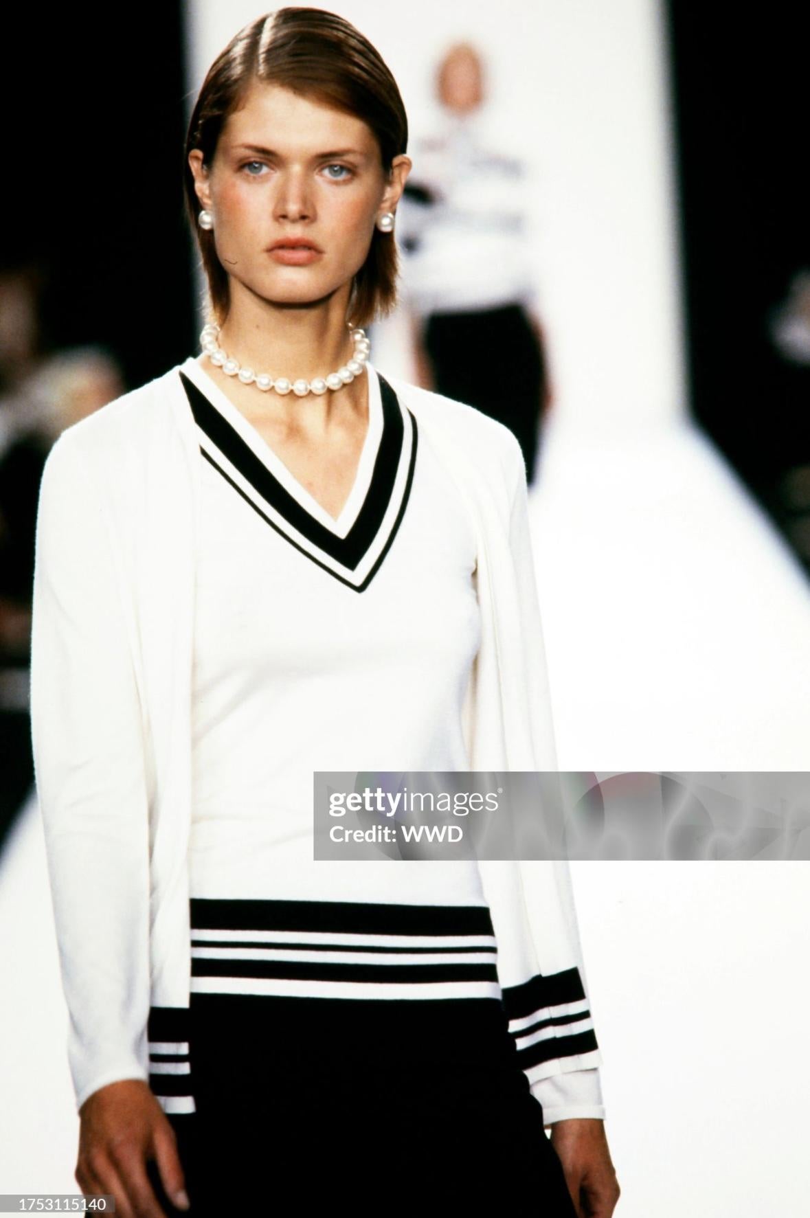 This off-white two-piece sweater set was showcased in Ralph Lauren's Spring/Summer 2001 Purple Label collection. It made its debut on the runway as part of look 26, worn by model Malgosia Bela. The set includes a sweater vest and a matching