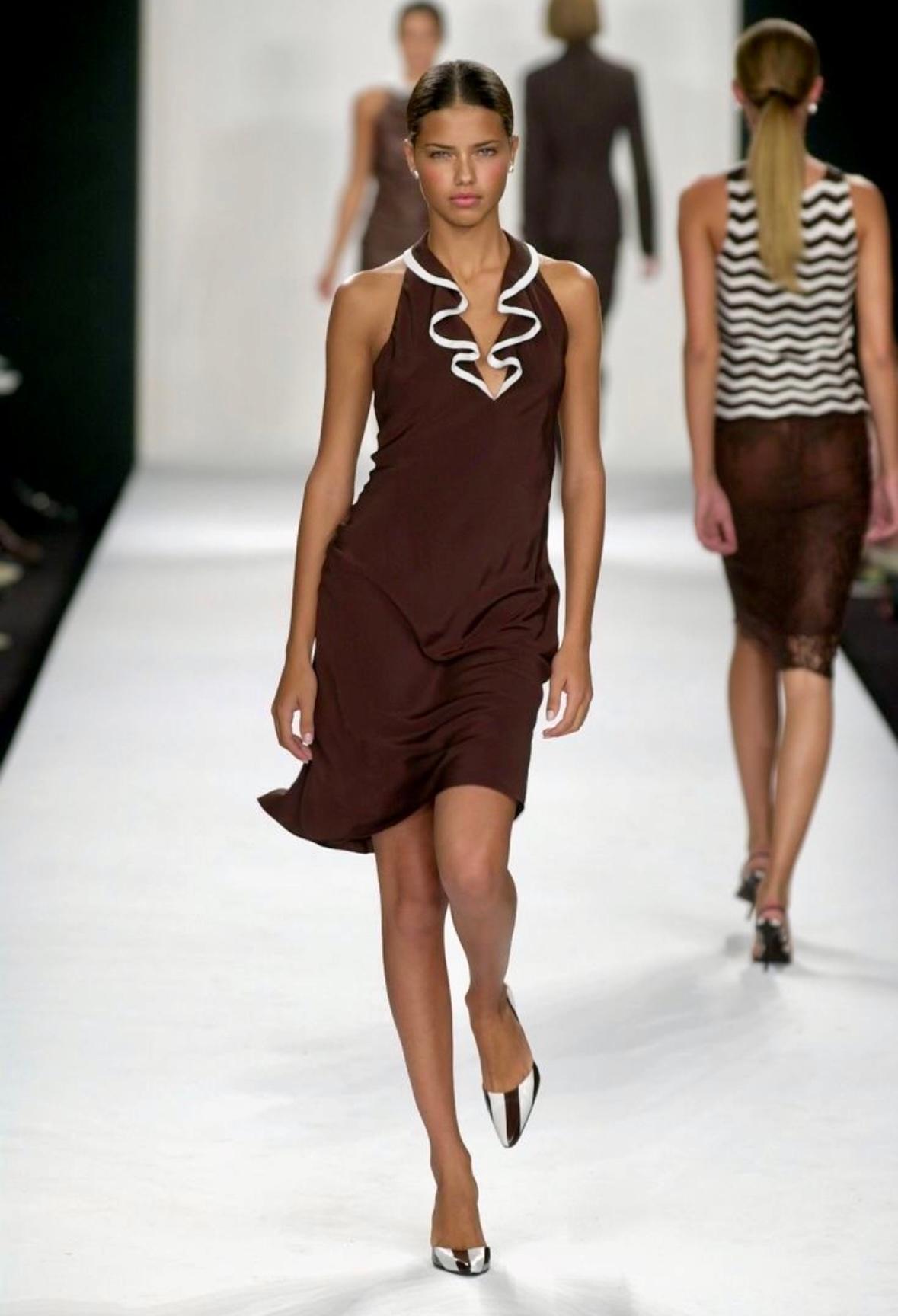 This brown silk dress from Ralph Lauren's Spring/Summer 2001 collection debuted on the season's runway on Adriana Lima and features a plunging halter neckline with ruffle detailing and an open back.

Approximate measurements:
Size - US4
Bust: 30