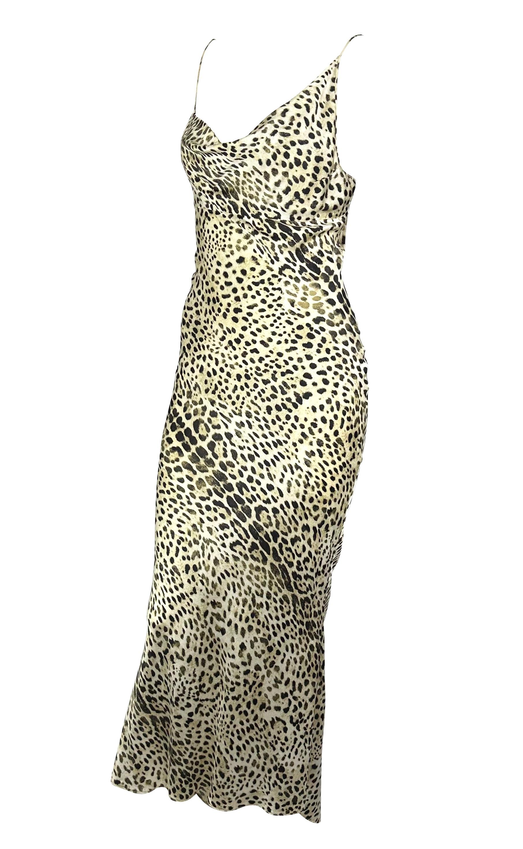 Presenting an incredible silk leopard print Roberto Cavalli bias cut gown. From the Spring/Summer 2001 collection, this fabulous full-length dress features spaghetti straps, an asymmetrical cowl neckline, and a flared hem cut. Bold animal prints are