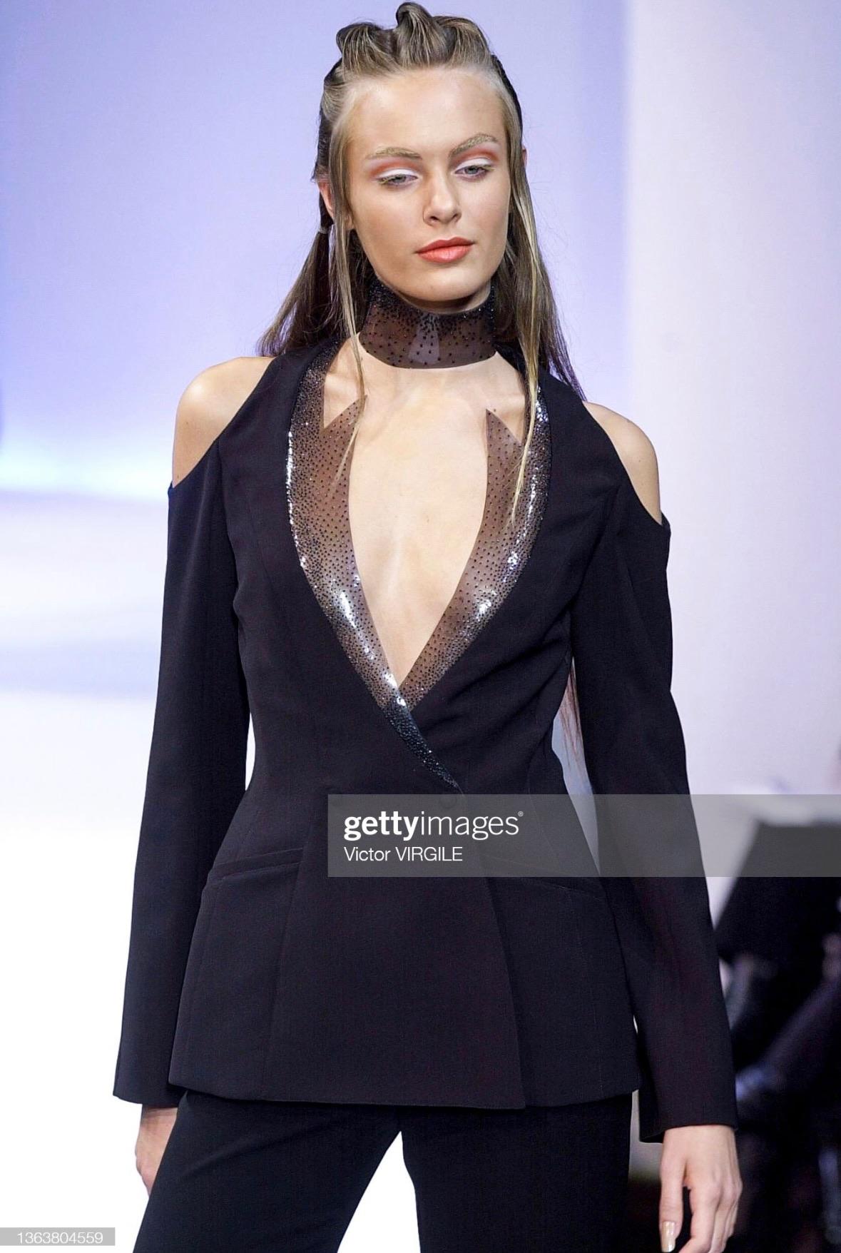 Presenting a gorgeous black Thierry Mugler blazer, designed by Manfred Mugler. From the Spring/Summer 2001 collection, this jacket debuted on the season's runway. Defined by its pointed angular PVC beaded accents at the neckline, this jacket