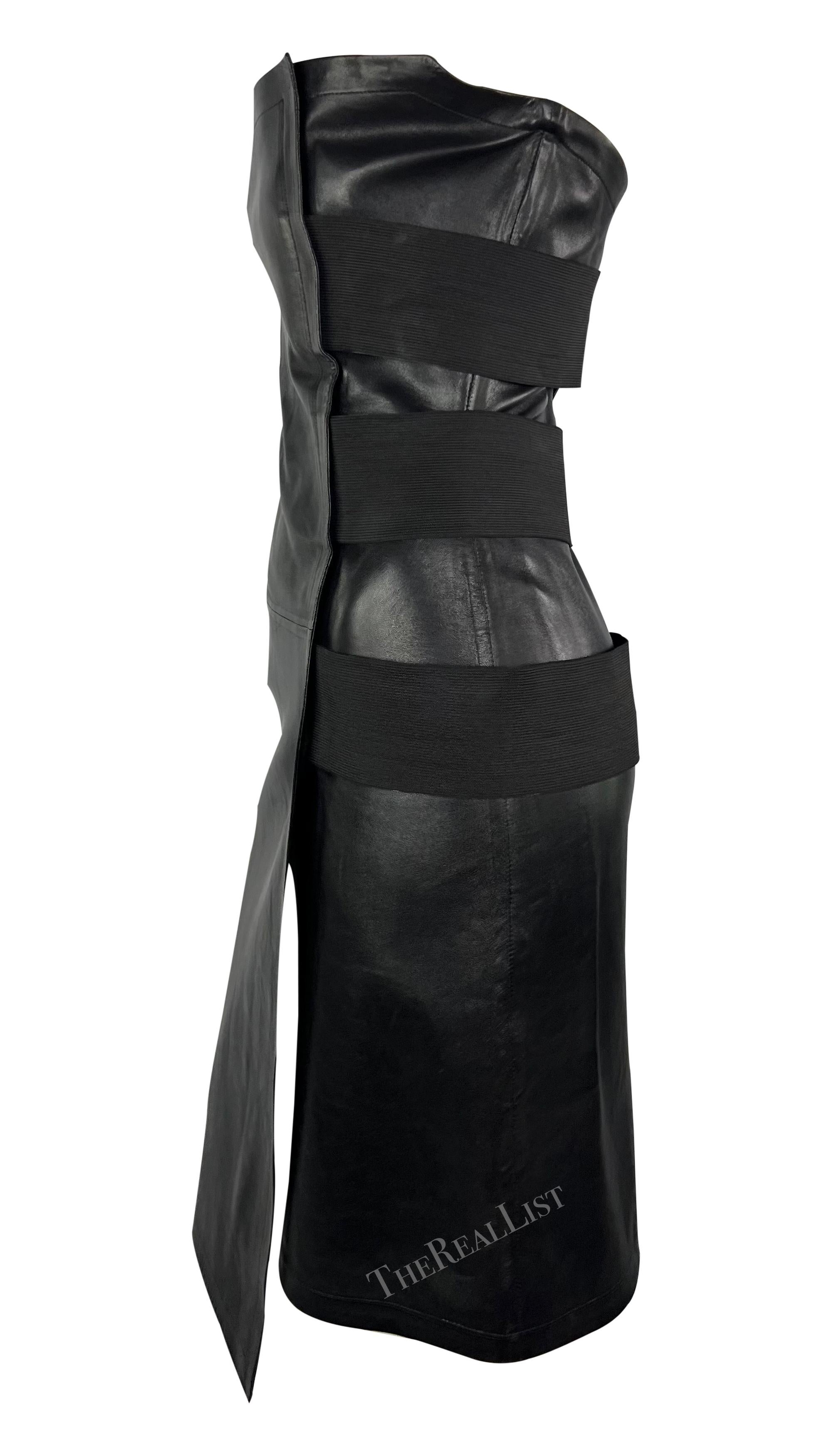 Presenting a fabulous black leather Yves Saint Laurent mini dress, designed by Tom Ford. From the Spring/Summer 2001 collection, this chic strapless dress is constructed entirely of black leather and wraps around the body, secured with large elastic