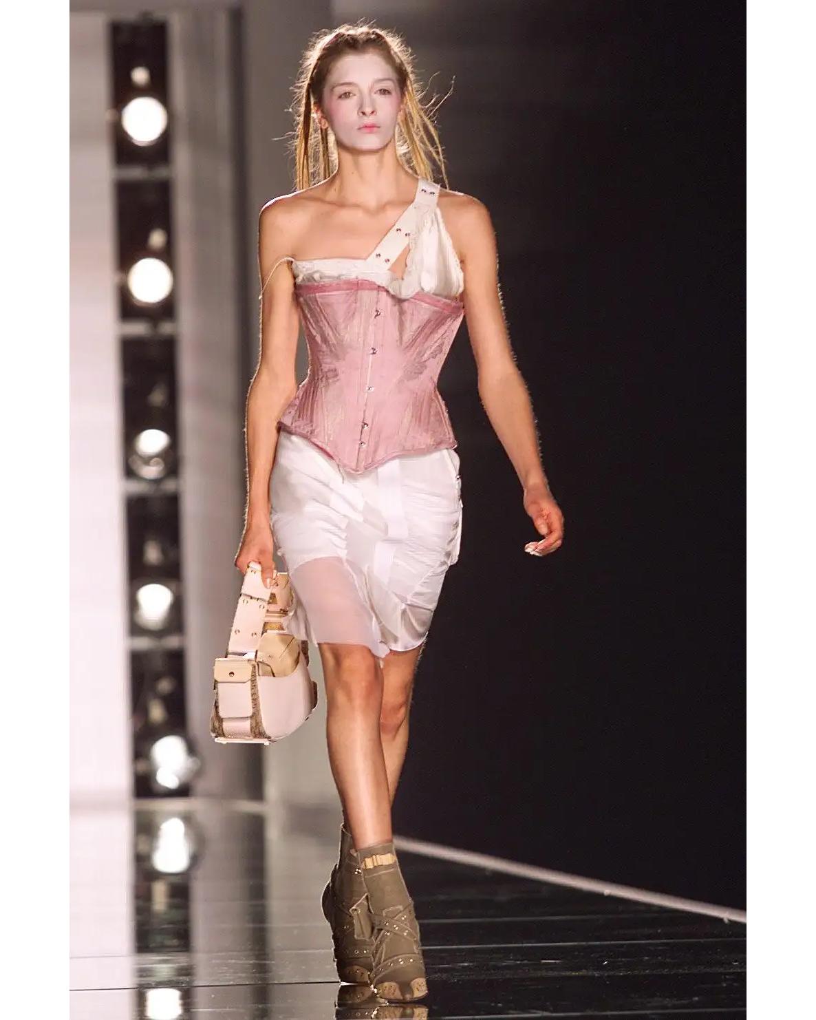 S/S 2002 Christian Dior by John Galliano white asymmetrical deconstructed mini skirt. Silk and nylon mesh skirt with deconstructed paneling detail throughout and functional cargo-inspired pocket at hip. Silver tone hardware with CD stamp. Fabric