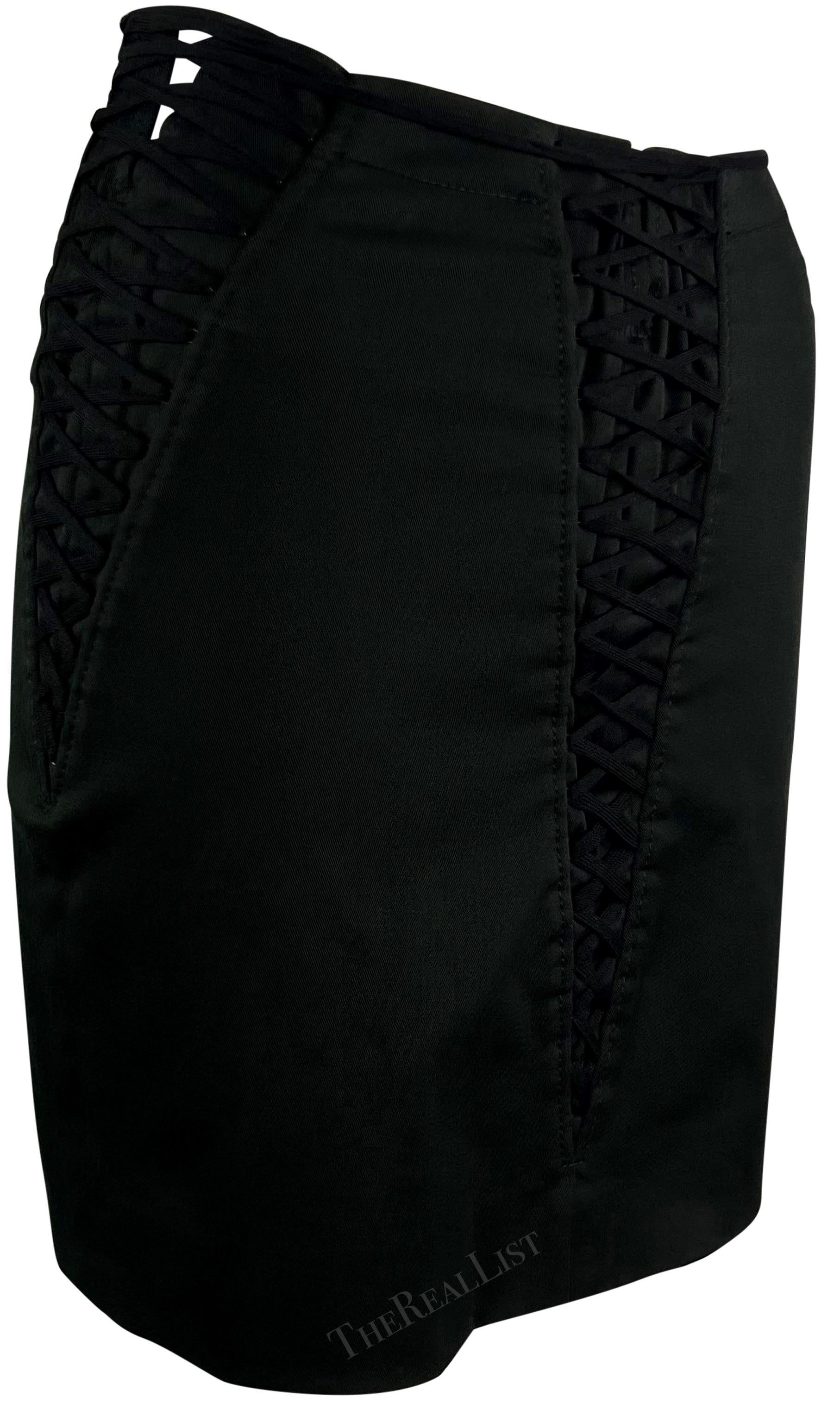 From the Spring/Summer 2002 collection, this chic Dolce & Gabbana short skirt features lace-up details on the front and sides that tapers off to create a v-shape. 

Approximate measurements:
Size - 38IT
Waistband to hem: 16