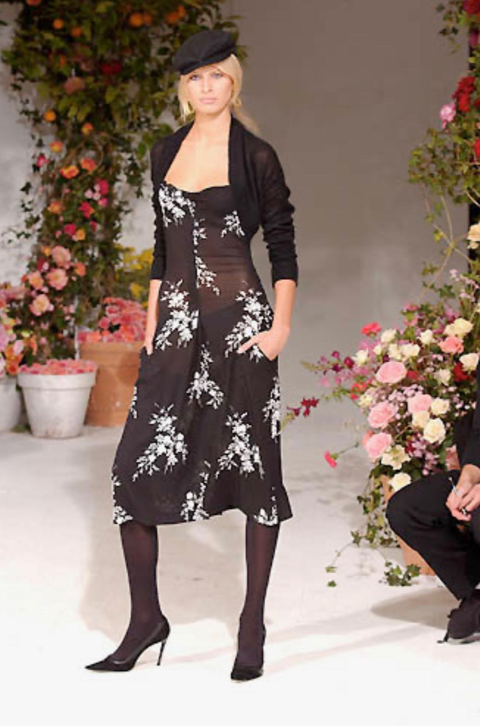 Presenting a stunning black and white floral Dolce and Gabbana mini dress. From the Spring/Summer 2002 collection, this dress debuted as part of look 14 modeled by Karolina Kurkova. This beautiful dress features a black and white floral print and is