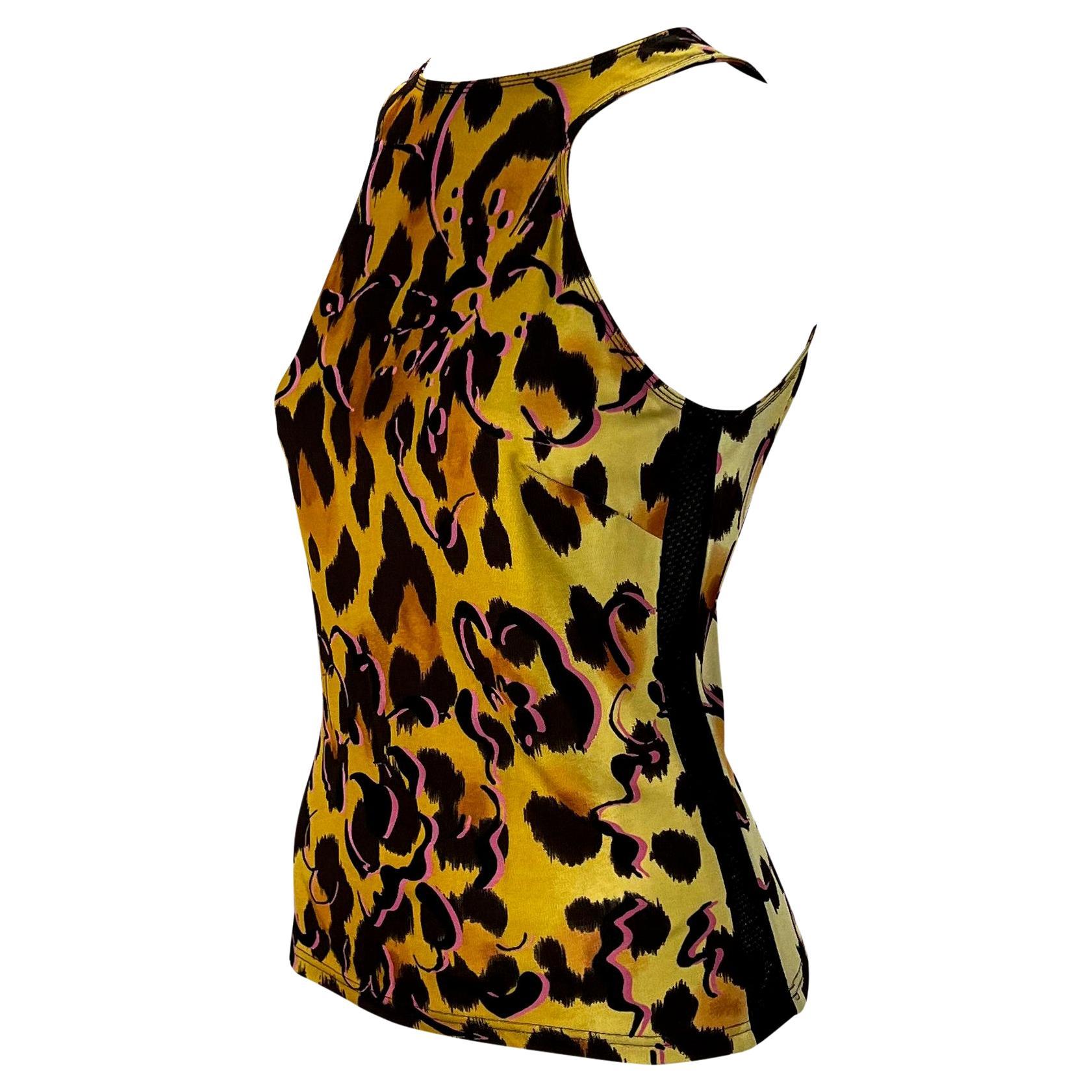 Presenting a fabulous cheetah print Gianni Versace Couture tank top, designed by Donatella Versace. From the Spring/Summer 2002 collection, this top is covered in a yellow cheetah print with pink flower outlines atop. The tank top features black