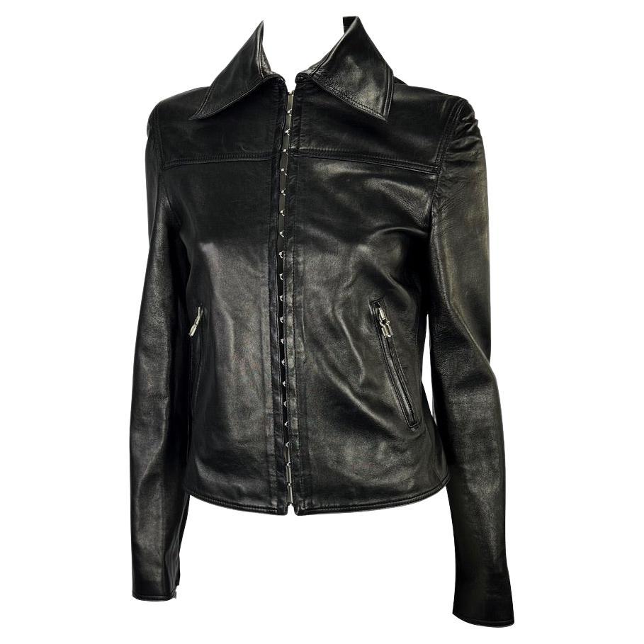 Presenting a sleek black Gianni Versace leather jacket, designed by Donatella Versace. This collared leather jacket features a row of hook and eye closures down its front, which was heavily featured on the Spring/Summer 2002 runway. This unique