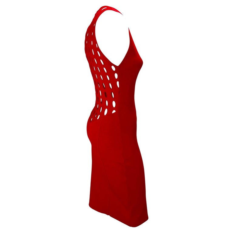 TheRealList presents: a bright red eyelet cut-out Gianni Versace Couture dress, designed by Donatella Versace. From the Spring/Summer 2002 collection, this vibrant sleeveless dress features a wide crew neckline and eyelet cutouts at the back. This