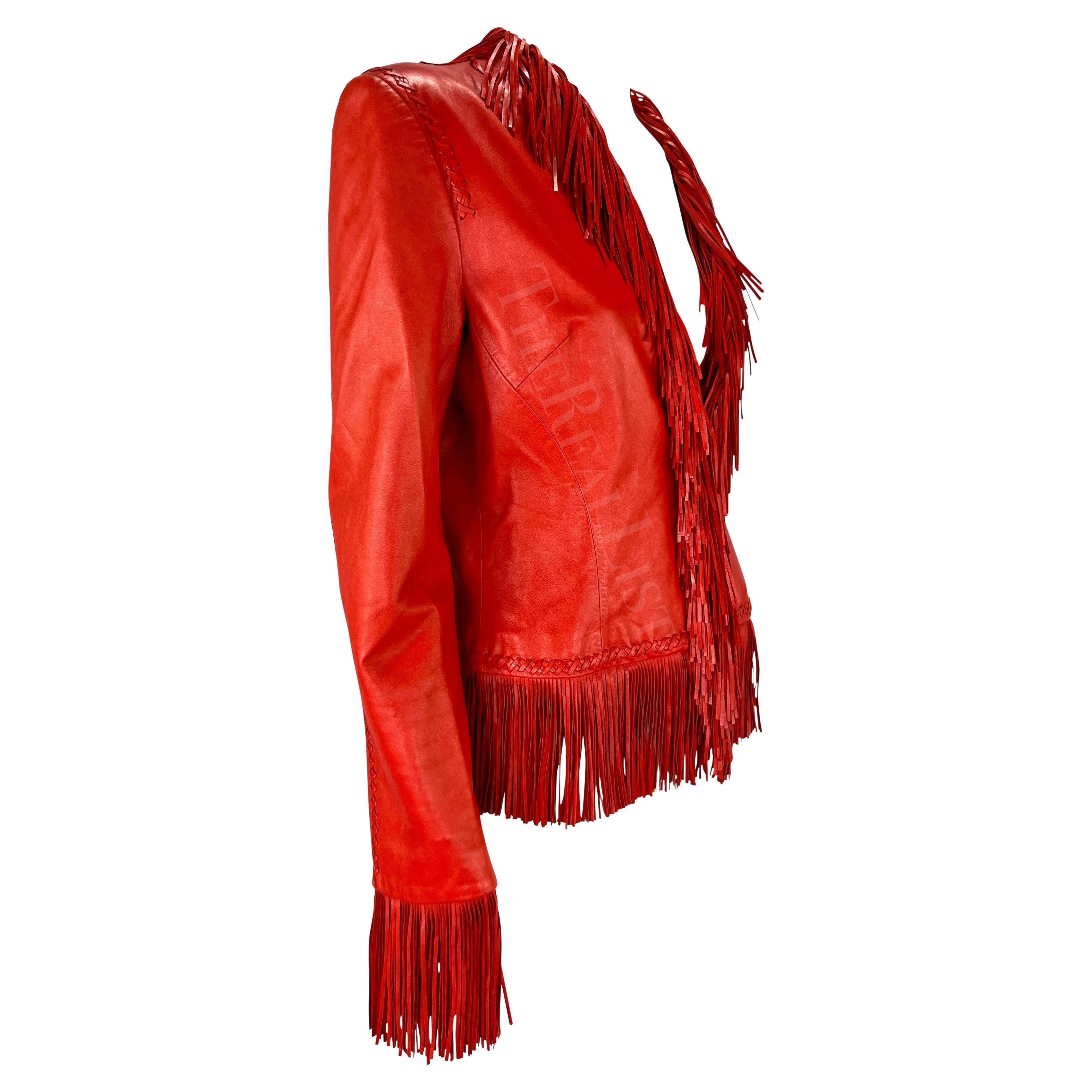 Presenting a fabulous bright red leather Gianni Versace jacket designed by Donatella Versace. Similar leather fringe pieces from the Spring/Summer 2002 collection debuted on the season's runway. This vibrant leather jacket features woven accents and