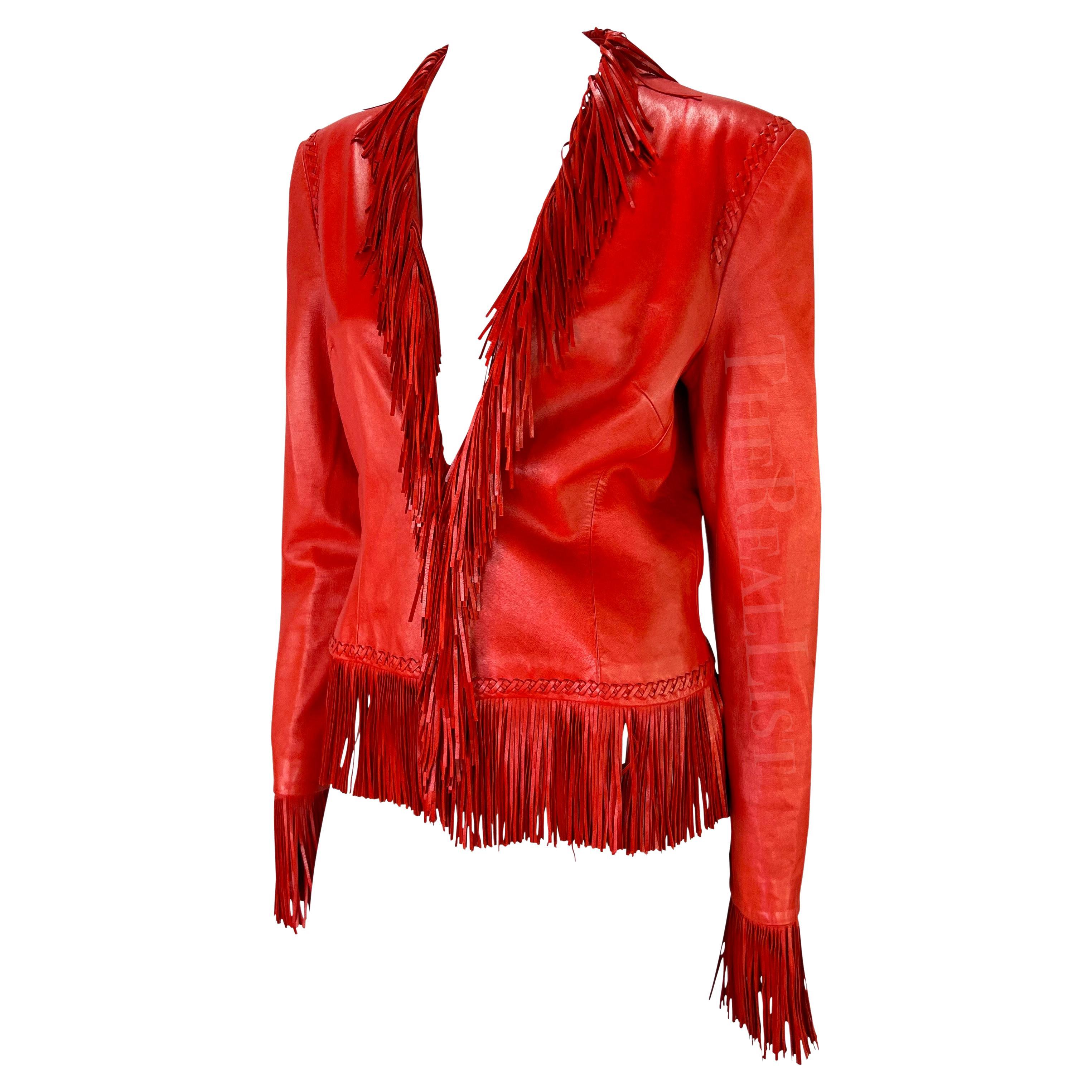 Presenting a fabulous bright red leather Gianni Versace jacket, designed by Donatella Versace. From the Spring/Summer 2002 collection, similar leather fringe pieces debuted on the season's runway. This vibrant leather jacket features woven accents,