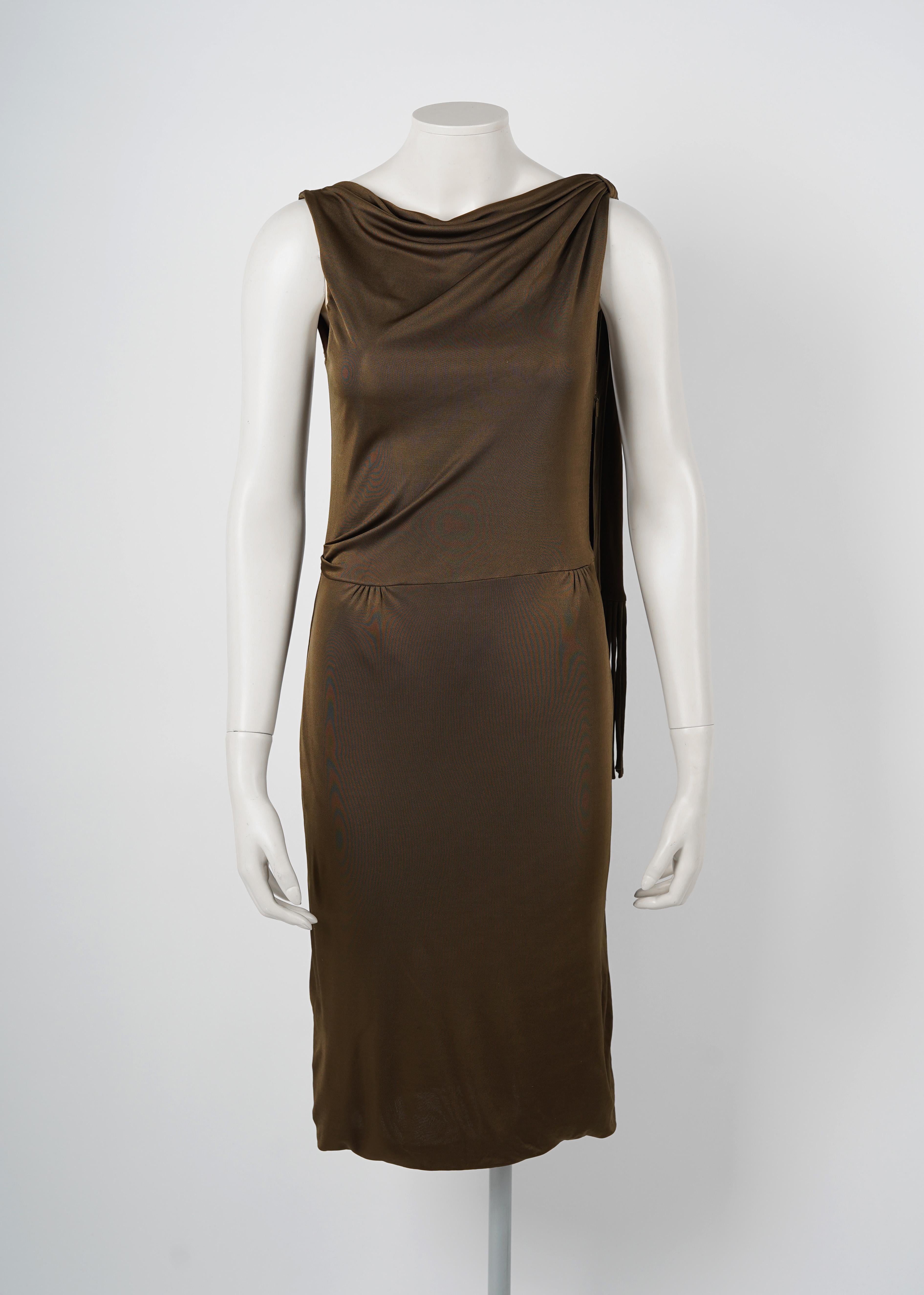 This dress is a striking piece from Gucci’s Spring/Summer 2002 collection, designed by Tom Ford during his iconic tenure at the fashion house. It exemplifies Ford’s signature blend of sensual minimalism and bold sophistication, offering a sleek