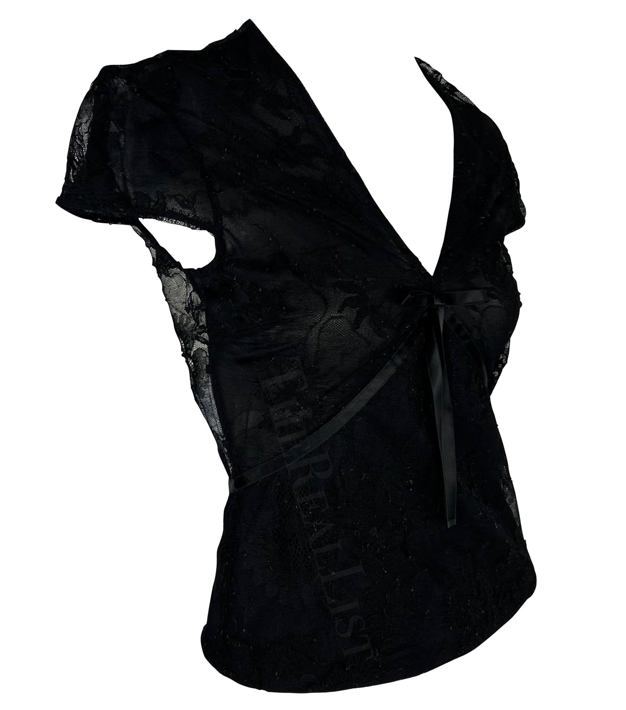 TheRealList presents: a chic black lace Gucci shirt, designed by Tom Ford. From the Spring/Summer 2002 collection, this top is constructed entirely of black lace and features a v-neckline with a bow between the breasts. The perfect elevated take on