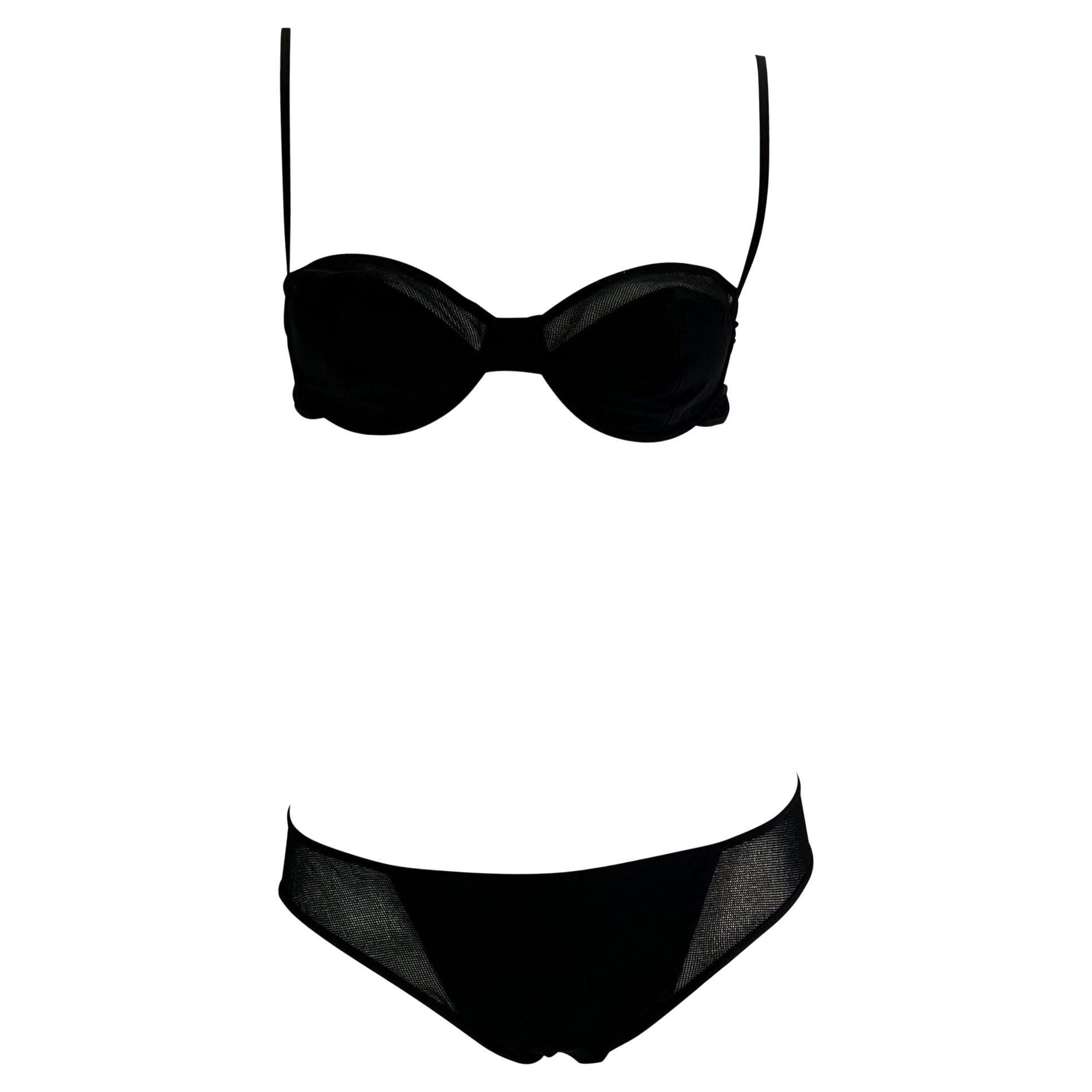 Presenting a sexy black mesh Gucci bikini, designed by Tom Ford. From the Spring/Summer 2002 collection, this new with tags bikini set consists of a bra style top and brief style bottoms. The top features mesh at the top of the cups and side straps,