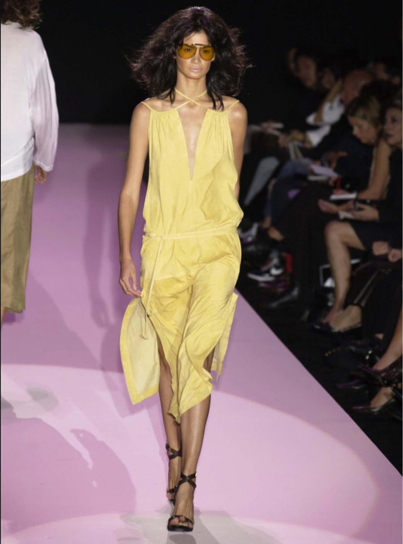 Presenting An absolutely fabulous tan suede dress from Gucci's Spring/Summer 2002 collection, designed by Tom Ford. Constructed purely of suede, this dress debuted on the season's runway and features a tie closure at the top as well as a suede