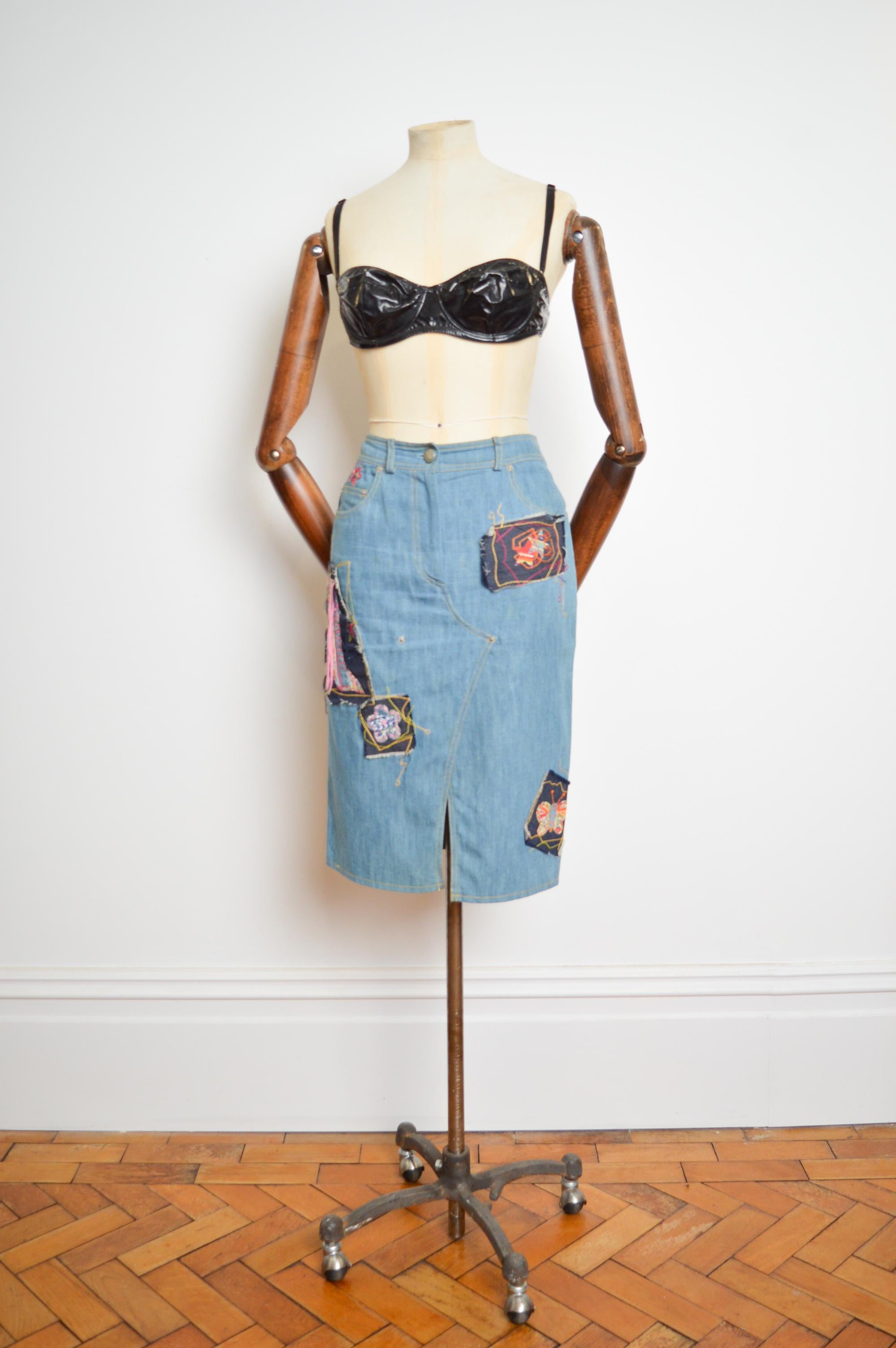 Spring / Summer 2002 John Galliano distressed Denim appliqué Runway skirt.    

American Vogue Wrote of this highly coveted Collection ; 'it was as if the designer had dipped his models in glue and dropped them into a haberdashers box of bits to see