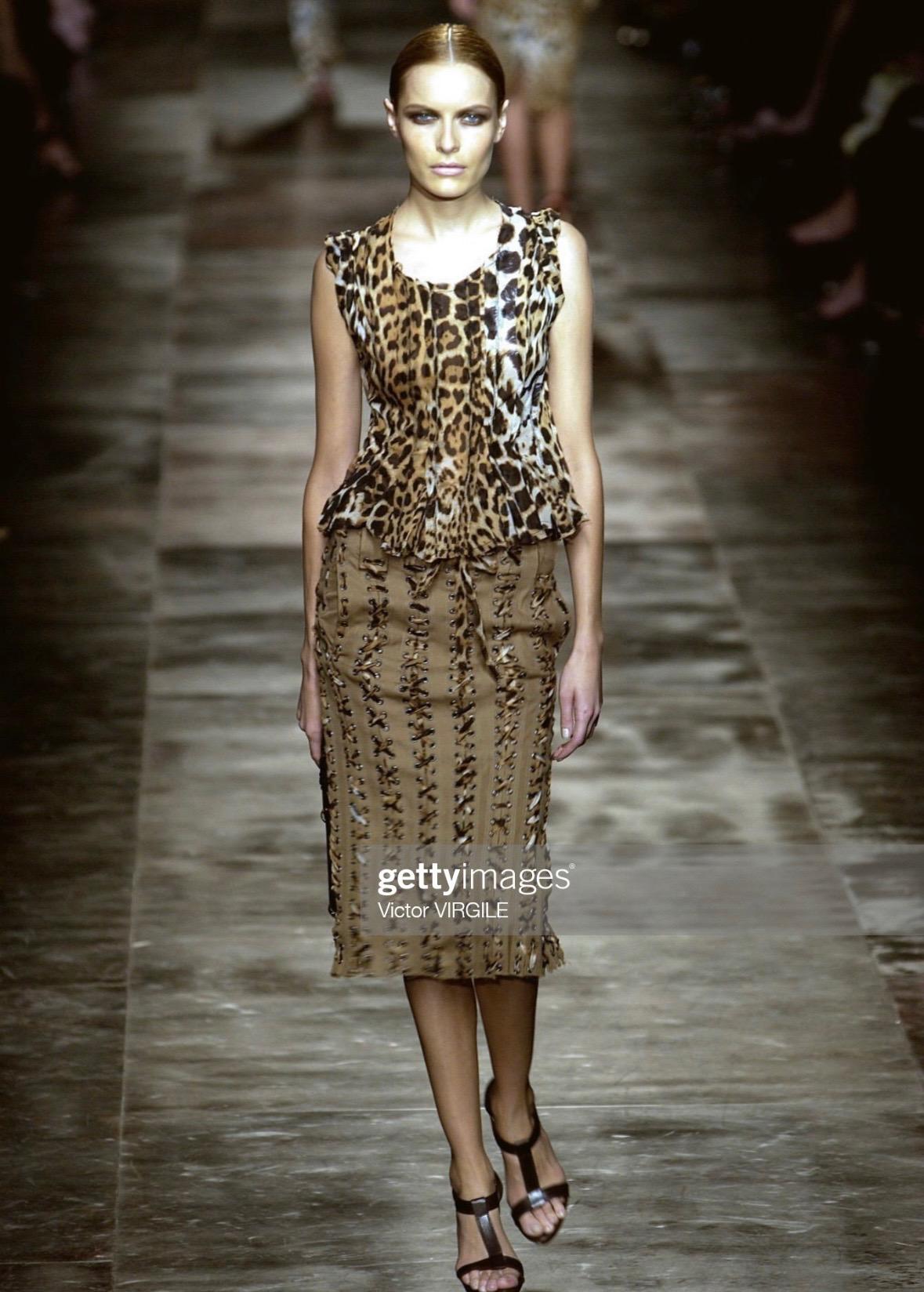 Presenting a chic Yves Saint Laurent Rive Gauche jaguar print top designed by Tom Ford for Spring/Summer 2002. This piece features a scoop neckline, oversized short sleeves, and a subtle peplum hem. Crafted from semi-sheer strips of raw-edged fabric