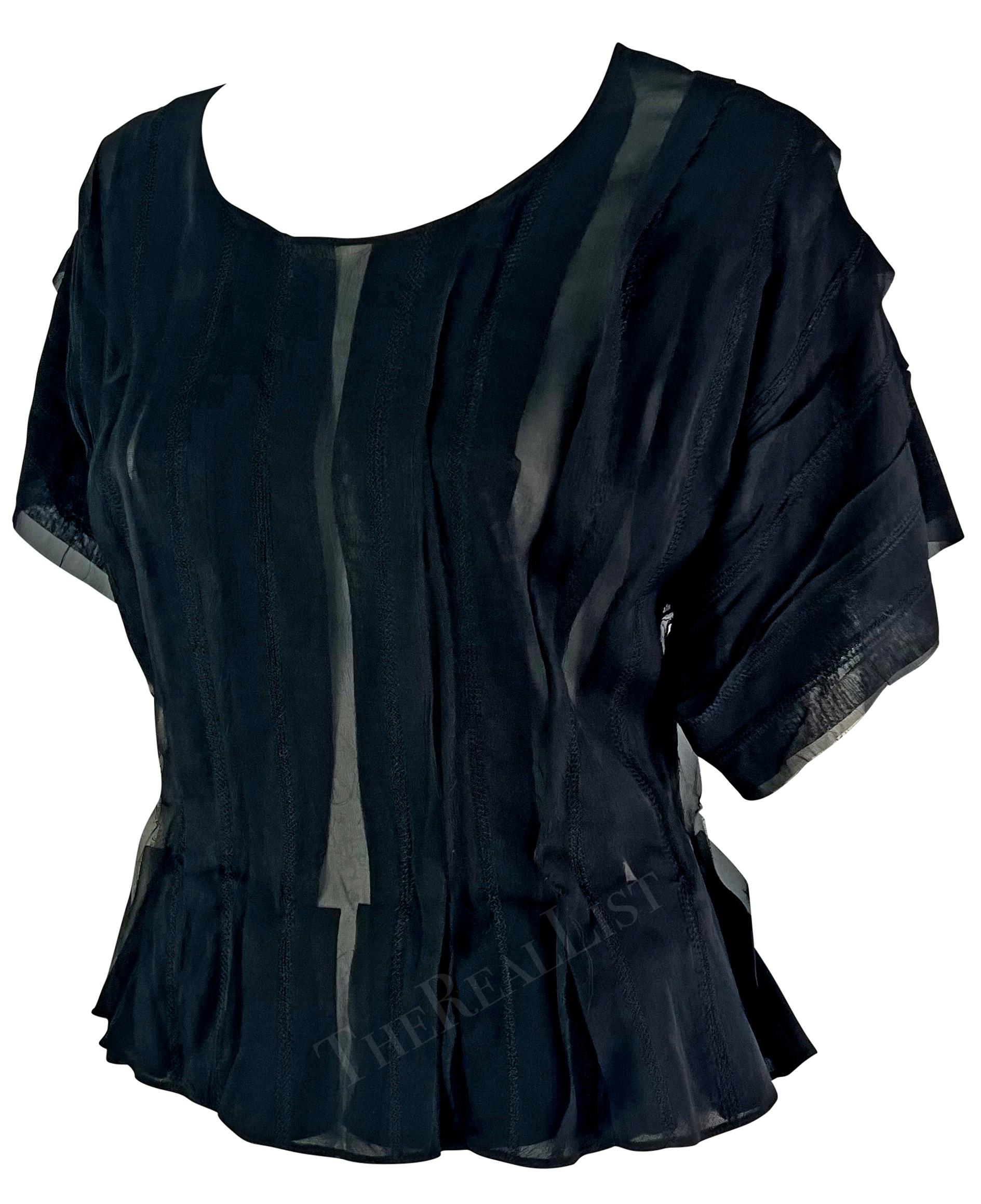 Presenting a fabulous black silk Yves Saint Laurent Rive Gauche short-sleeve top, designed by Tom Ford. From the Spring/Summer 2002 collection, this sheer top features vertical ribbons, a scoop neckline, oversized sleeves, and a light peplum.