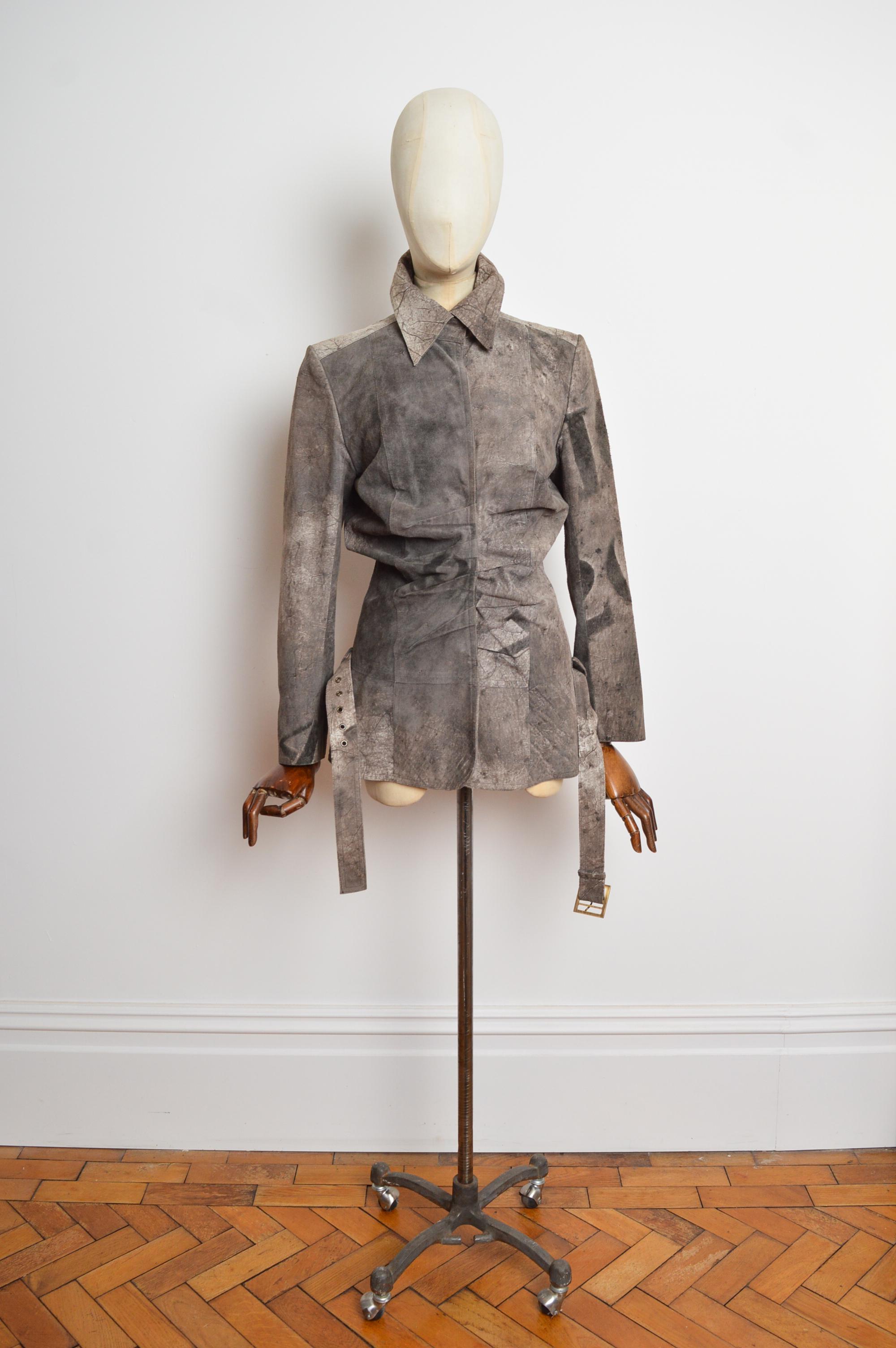 Spring / Summer 2003 Christian Dior by John Galliano Blazer. 
Superbly crafted from a soft calf skin material with printed ‘DIOR 2003’ Logo across the back, Ruched drapery, press stud closure and original hip belt. 
Size; Recommended U.K. 6-8