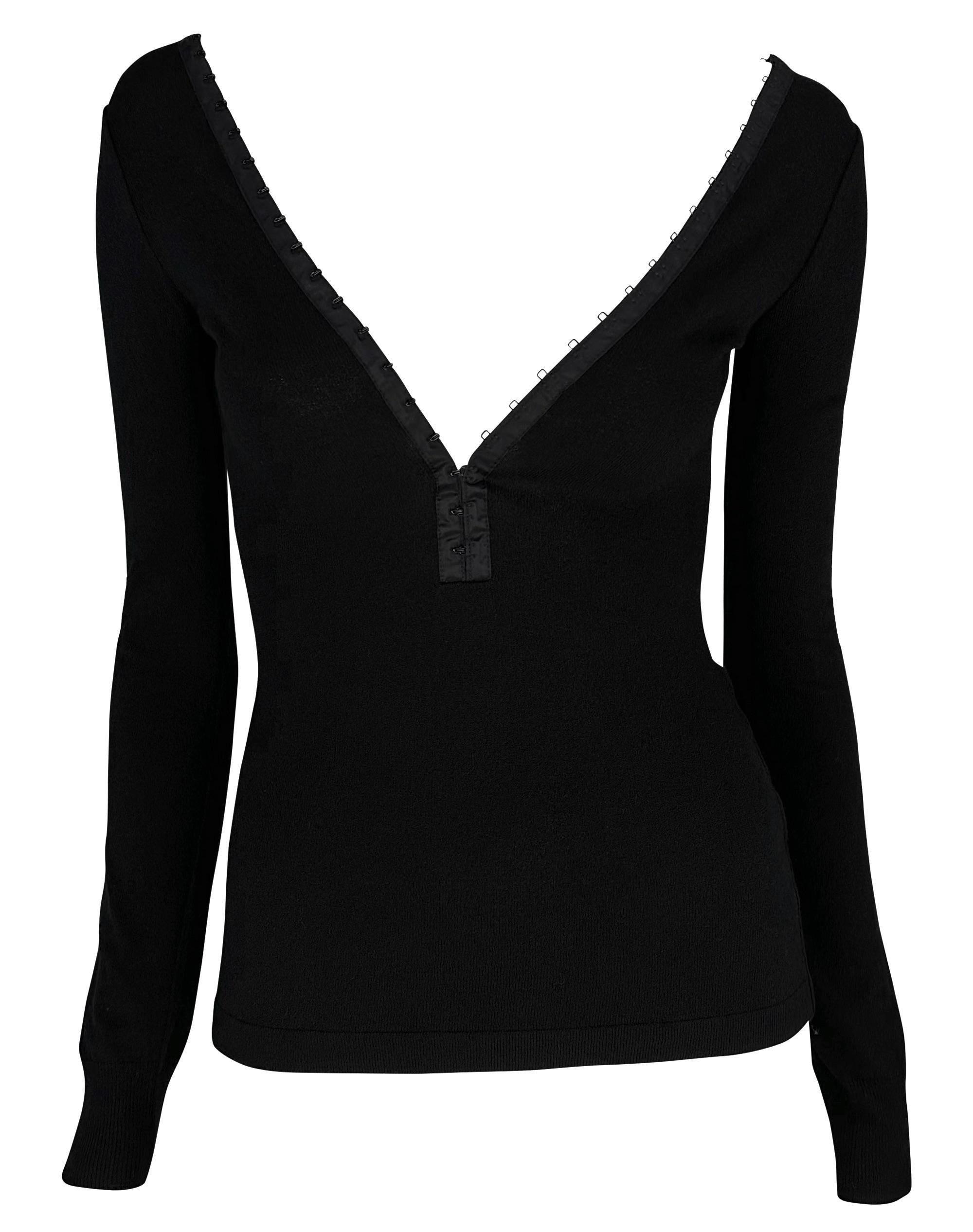 This fabulous black knit long-sleeve top, featuring a plunging neckline, is from the Spring/Summer 2003 Dolce & Gabbana 'Sex and Love' collection. The top features hook and eye closures that line the plunging v-neckline and extend to the back. 