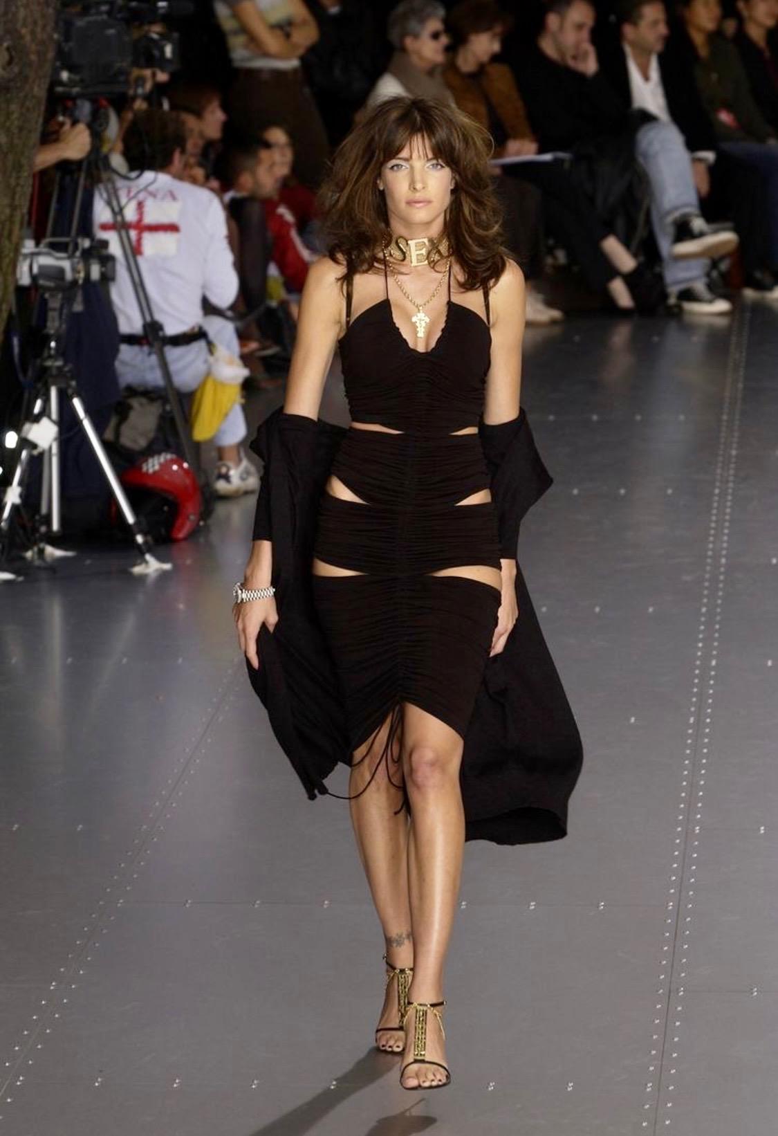 TheRealList presents: a black stretchy cut-out Dolce and Gabbana dress. From the brand's famous Spring/Summer 2003 'Sex and Love' collection, this dress debuted on the season's runway as look number 9 on Stephanie Seymour. This collection was