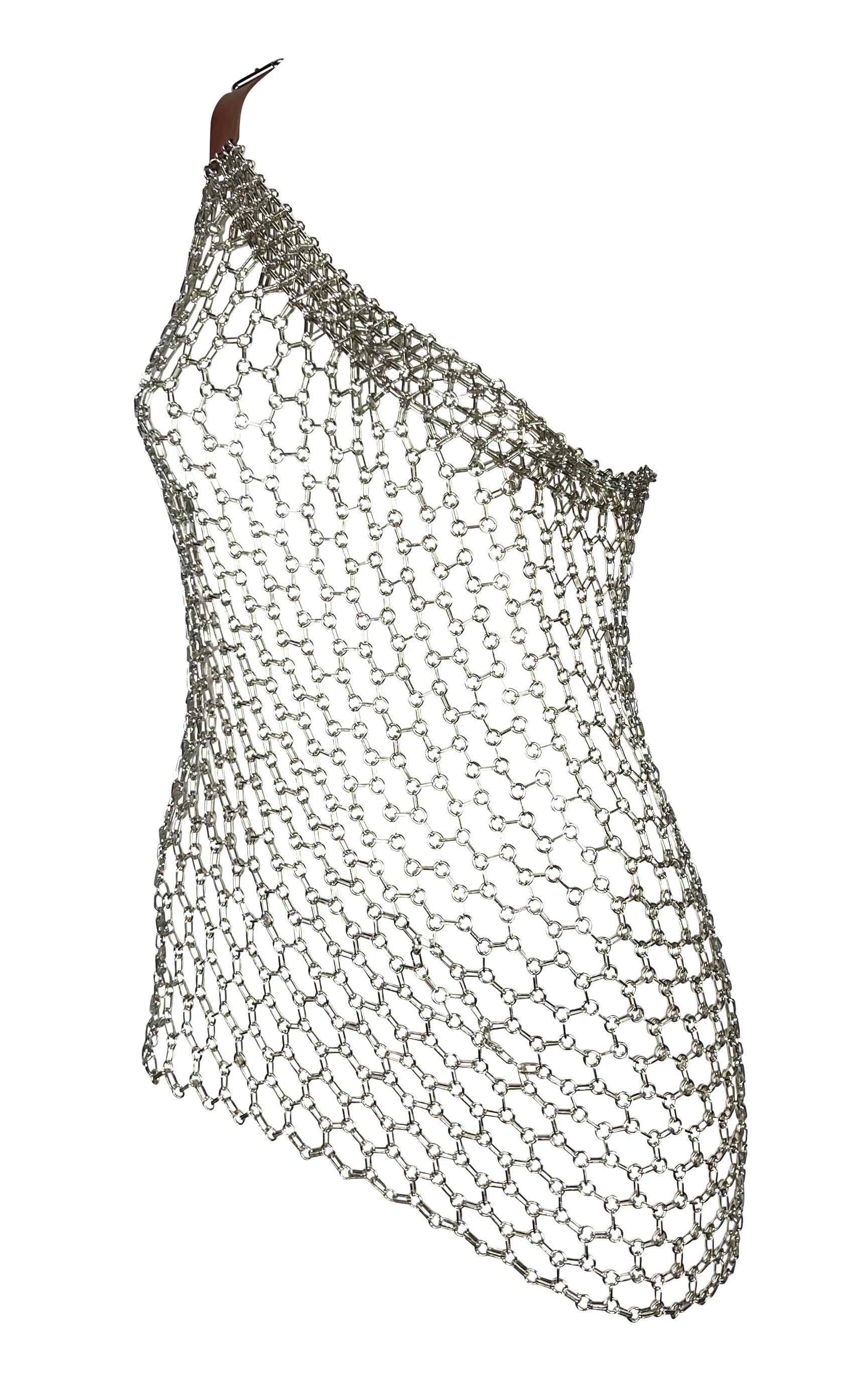 Presenting a silvertone Dolce and Gabbana chainmail metal buckle top. From the Spring/Summer 2003 'Sex & Love' collection, this top features a single-shoulder design and a tanned leather adjustable belt as the shoulder strap. Inspired by the
